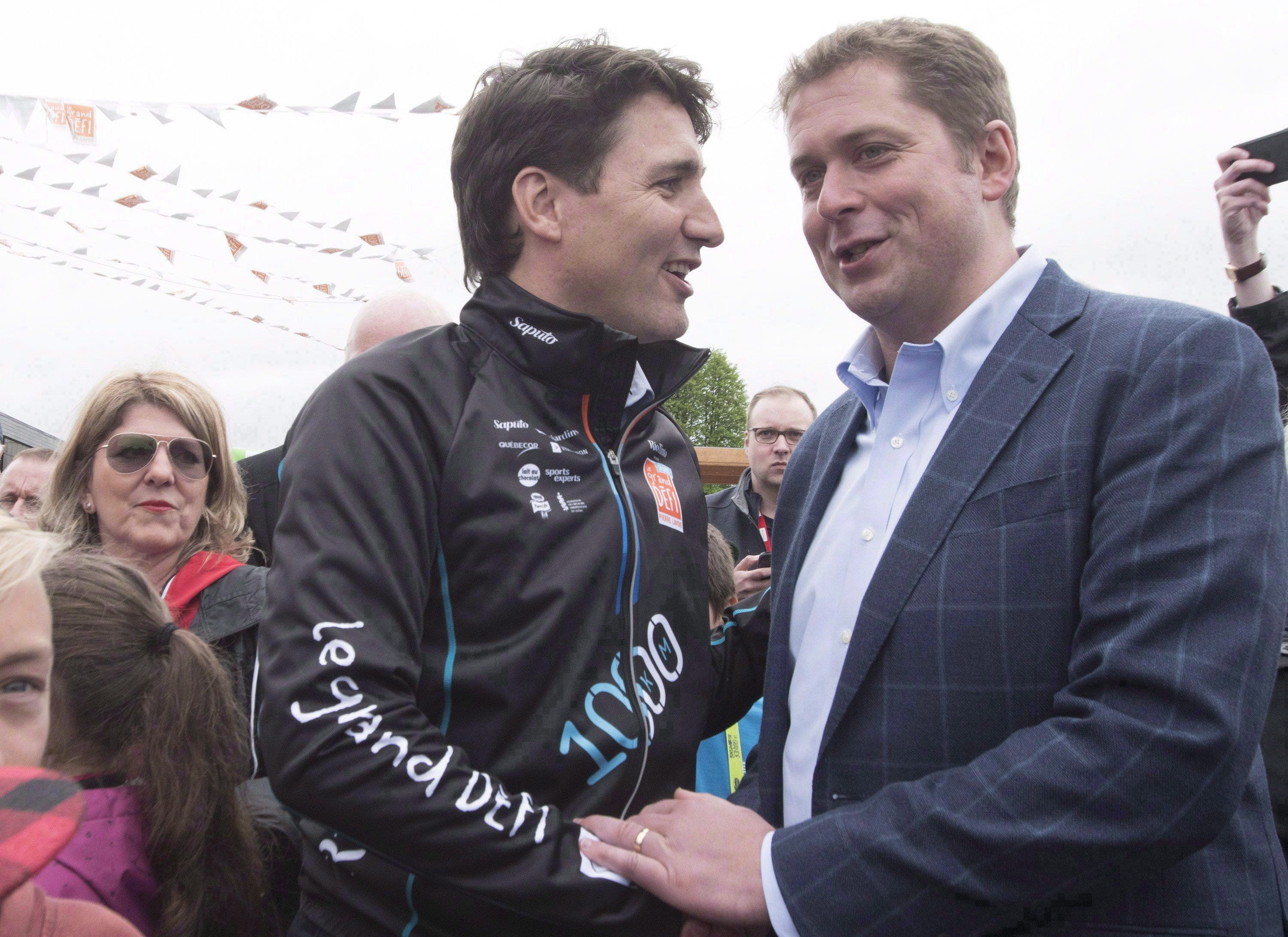 Trudeau shakes hand with Scheer at the start of the Defi Pierre Lavoie, a 1,000 km bicycle trek, on Thursday, June 14, 2018 in Saguenay Que. (THE CANADIAN PRESS/Jacques Boissinot)