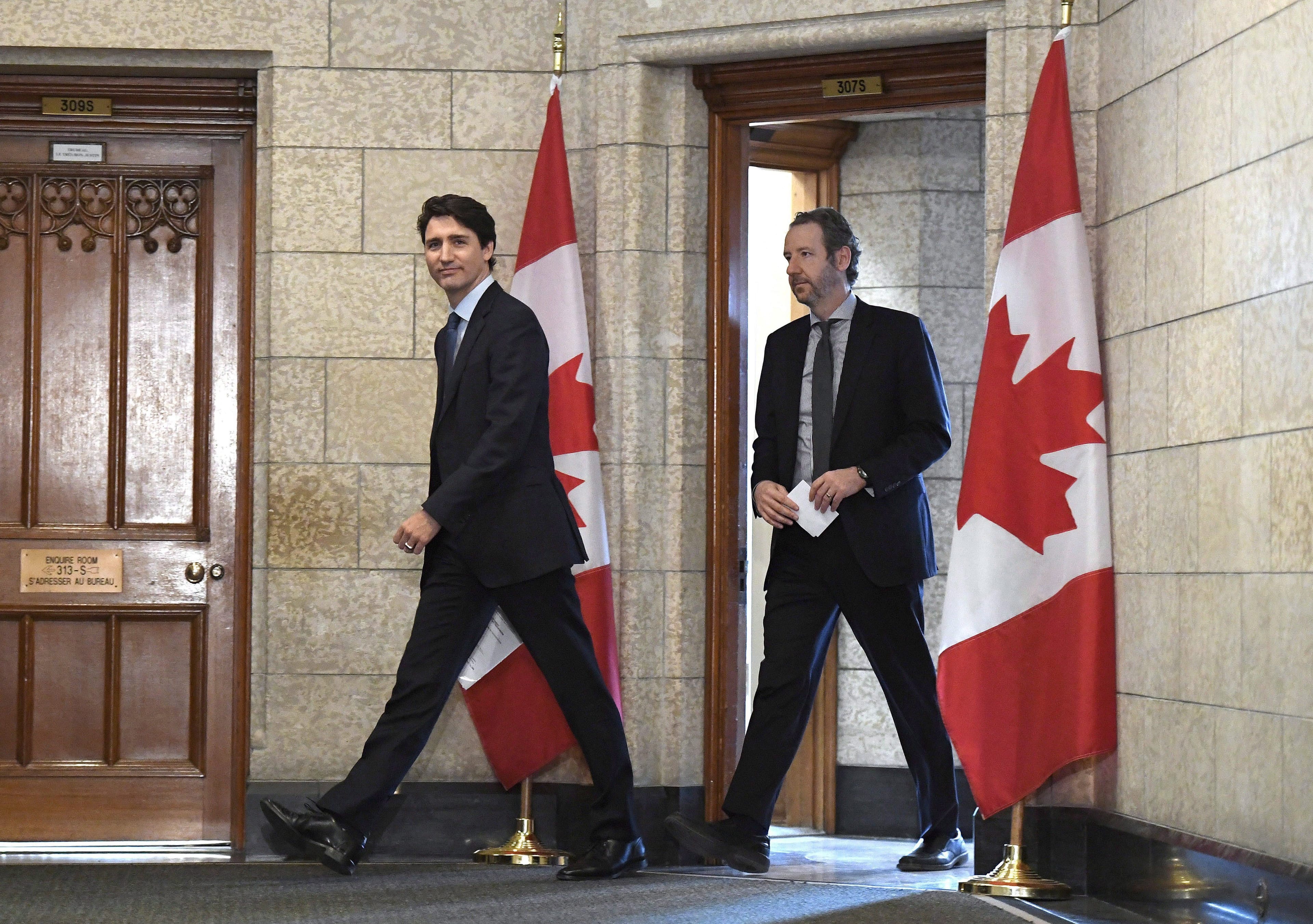 Trudeau leaves his office with his principal secretary Gerald Butts to attend an emergency cabinet meeting on Parliament Hill in Ottawa on Tuesday, April 10, 2018. (Justin Tang/CP)