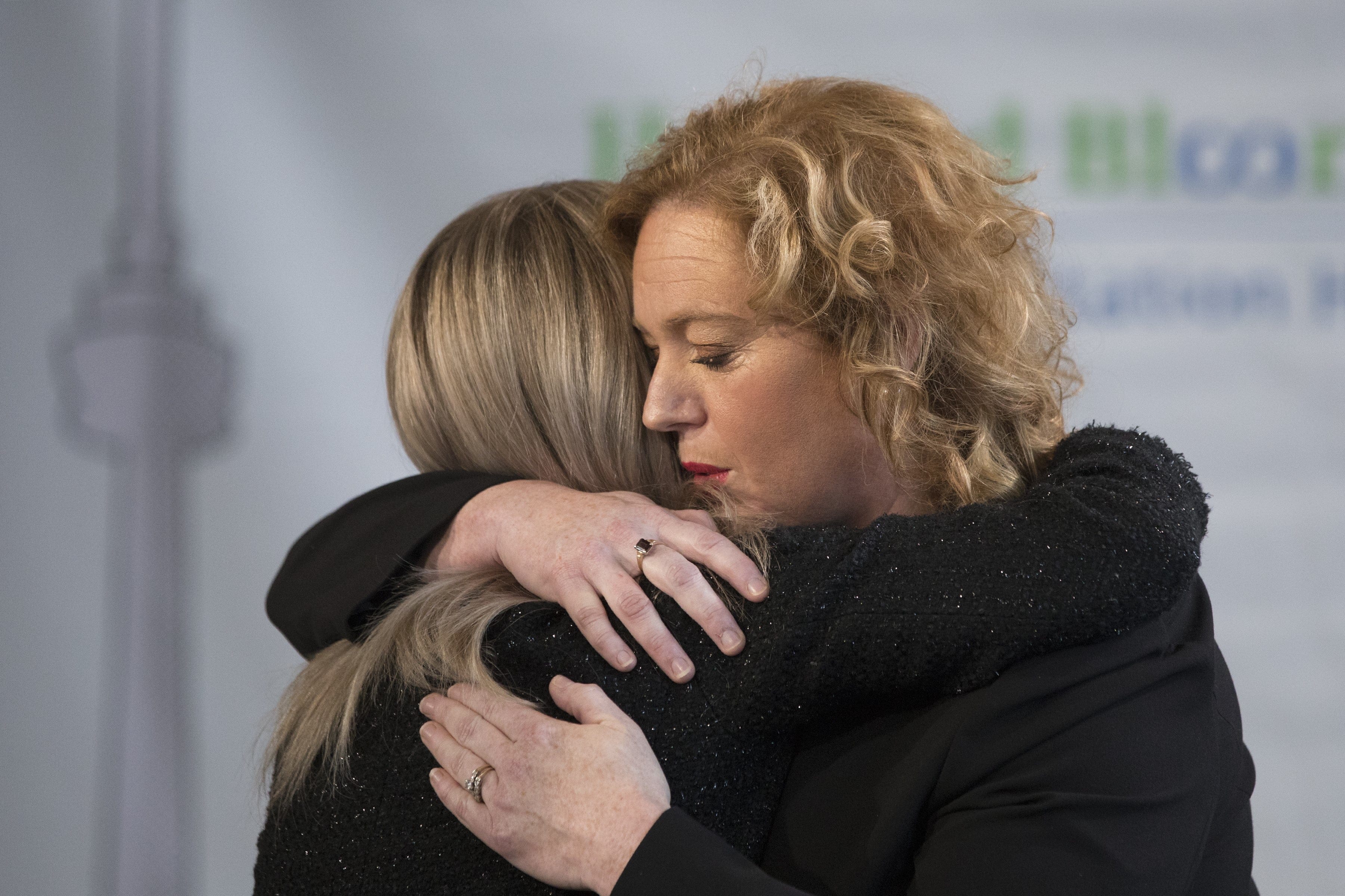 Lisa MacLeod, right, Ontario's Minister of Children, Community and Social Services, hugs her Parliamentary Assistant Amy Fee, who is a mother of two children with Autism, during an announcement in Toronto, on Wednesday, February 6, 2019. (THE CANADIAN PRESS/Chris Young)