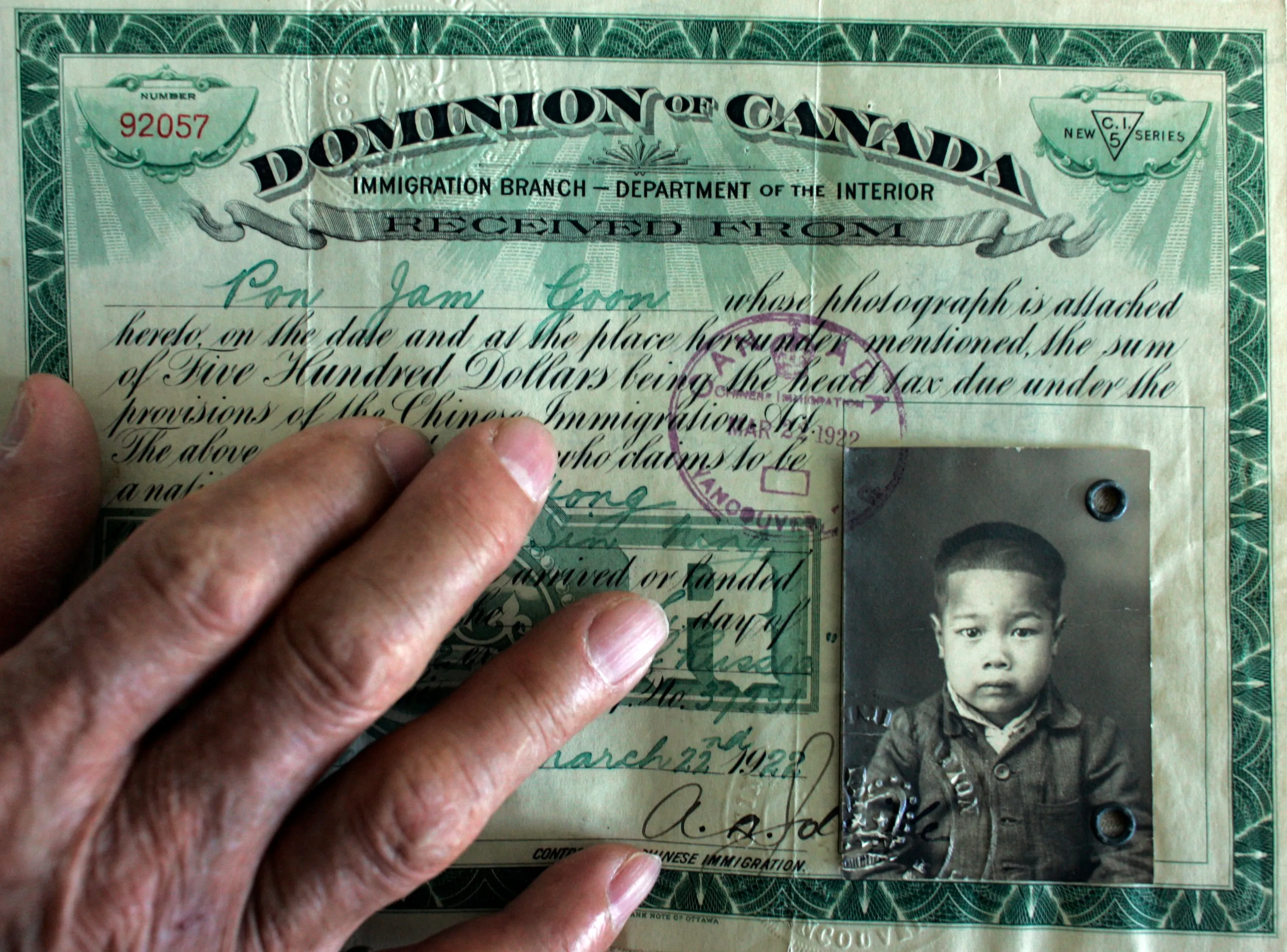 James Pon, 88, has the original documents showing the Chinese Head Tax paid ($500), for each his mother and him, in 1922. (Peter Power/Toronto Star/Getty Images)