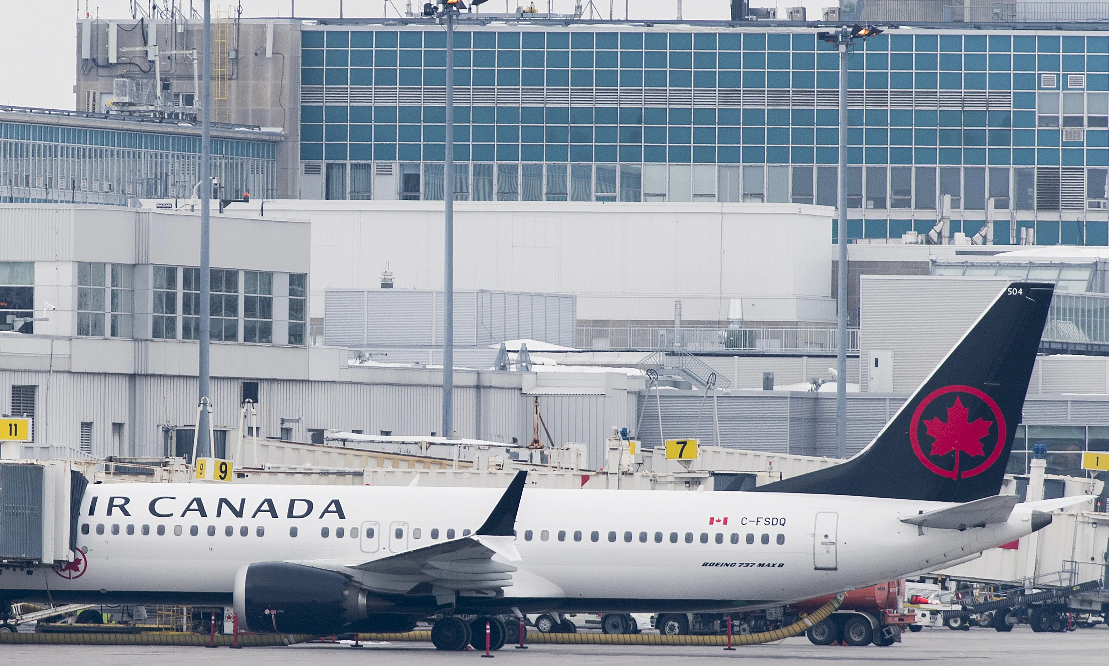 An Air Canada Boeing 737 Max 8 aircraft is shown next to a gate at Trudeau Airport in Montreal, Wednesday, March 13, 2019. (THE CANADIAN PRESS/Graham Hughes)