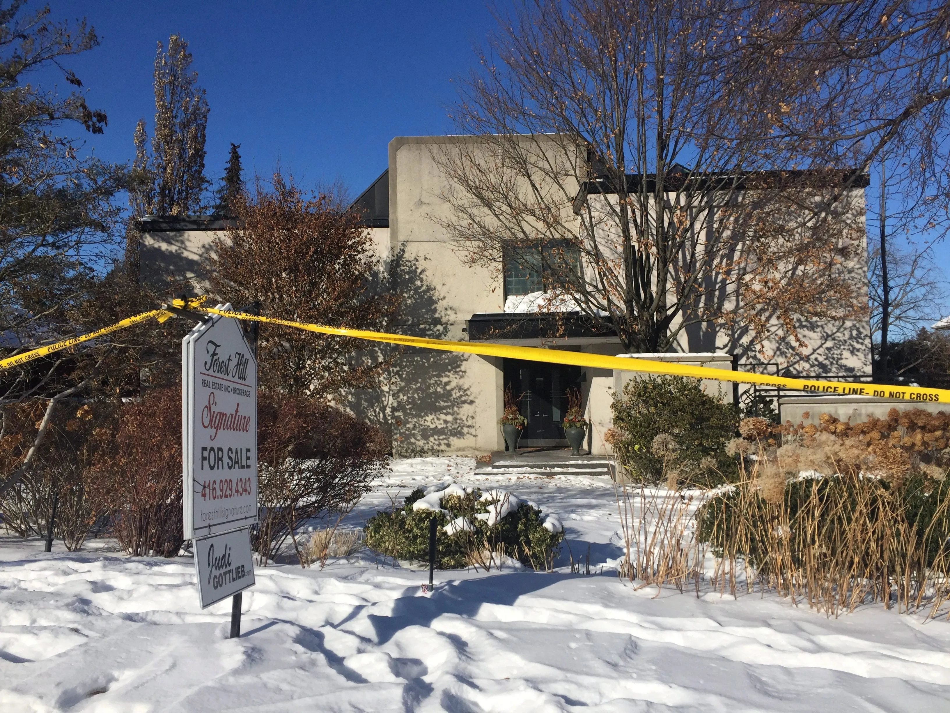 This Jan. 6, 2018 photo shows police crime scene tape marking off the property belonging to Barry and Honey Sherman, who were found strangled inside their home on Dec. 15, 2017. Since that time, investigators have scoured the 12,000-square foot home, hauled away the couple's cars and even checked the sewers in one of Toronto's most exclusive neighborhoods for clues. But police haven't made any arrests, announced the search for any suspects or said practically anything publicly about the deaths of the drug company founder and his wife. (AP Photo/Rob Gillies)