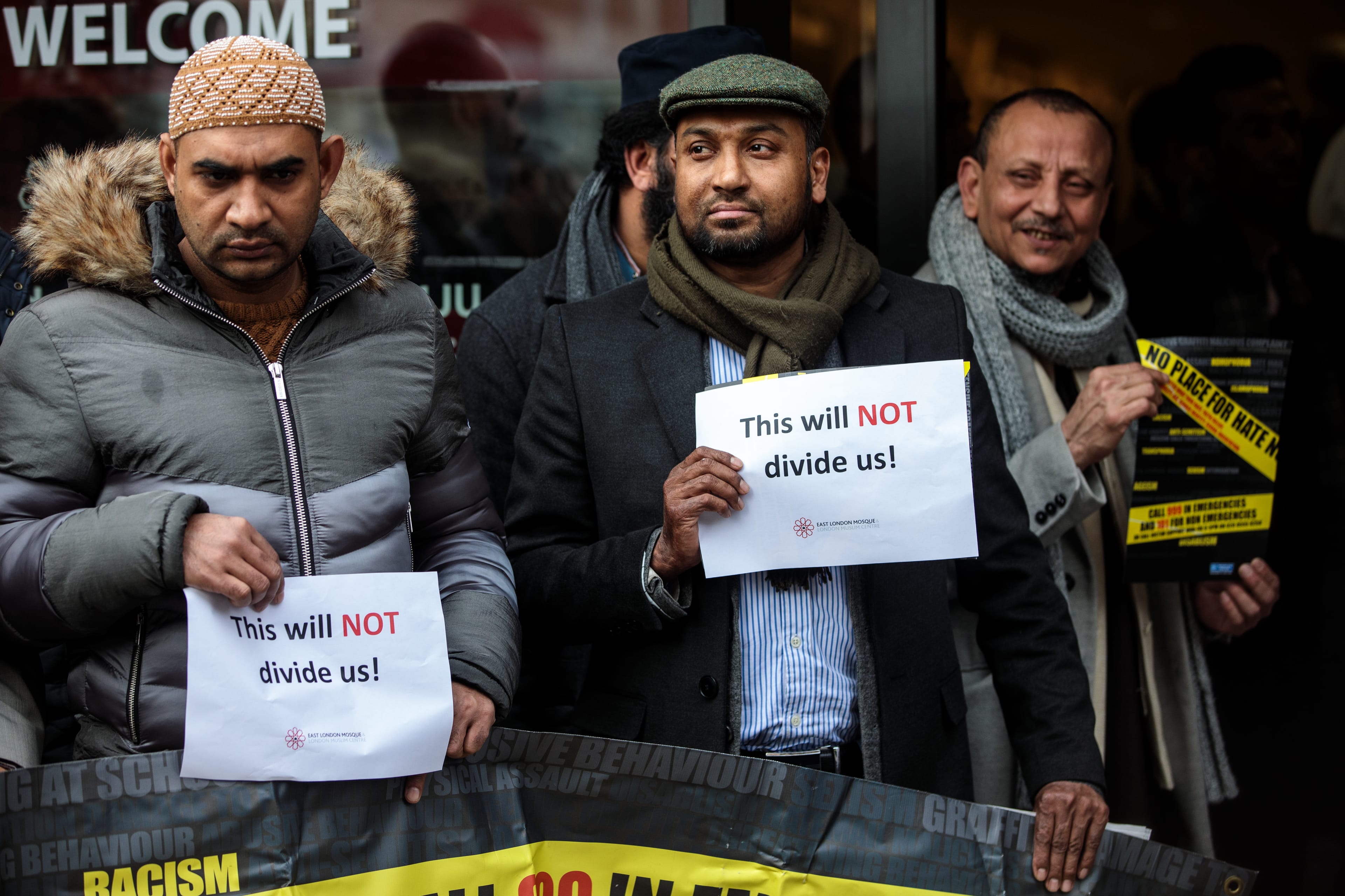 People hold up signs with the words 'This will not divide us' as they attend a vigil at the East London Mosque for the victims of the New Zealand mosque attacks on March 15, 2019 in London, England. (Photo by Jack Taylor/Getty Images)