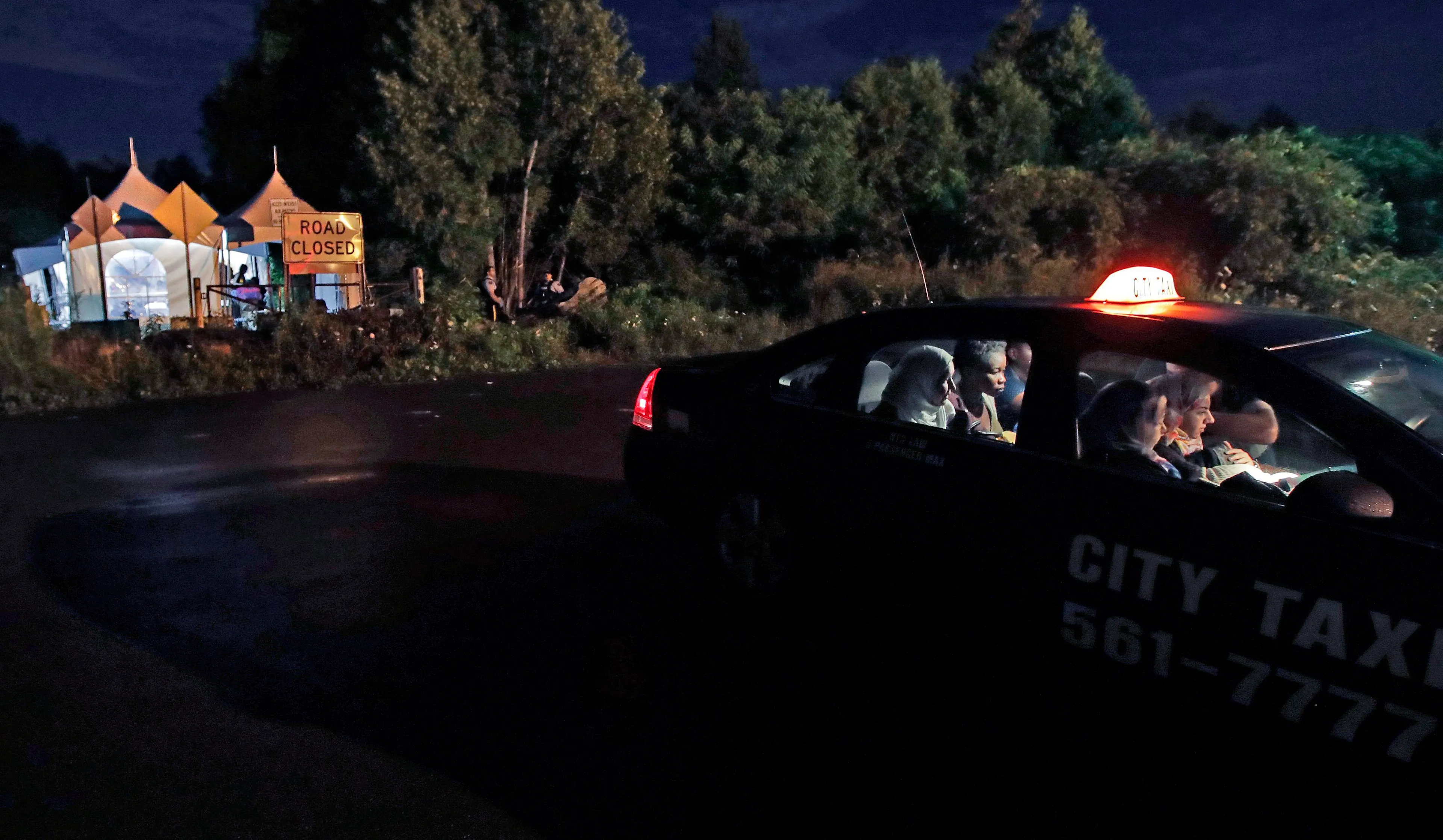 A taxi arrives at an unofficial border station across from Saint-Bernard-de-Lacolle, Que., on Roxham Road in Champlain, N.Y., early Tuesday, Aug. 8, 2017. (Charles Krupa/AP)