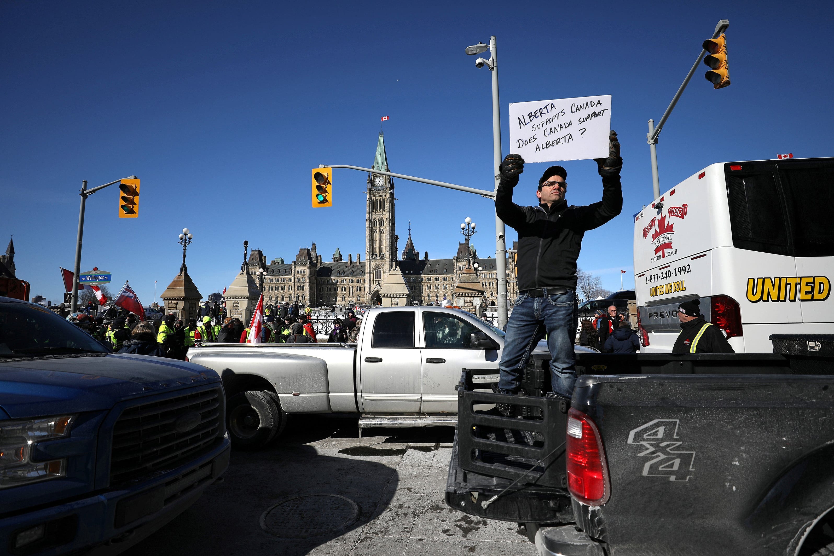 A member of the United We Roll protest convoy holds a sign during a two-day demonstration in front of Parliament Hill (Chris Wattie/Reuters)