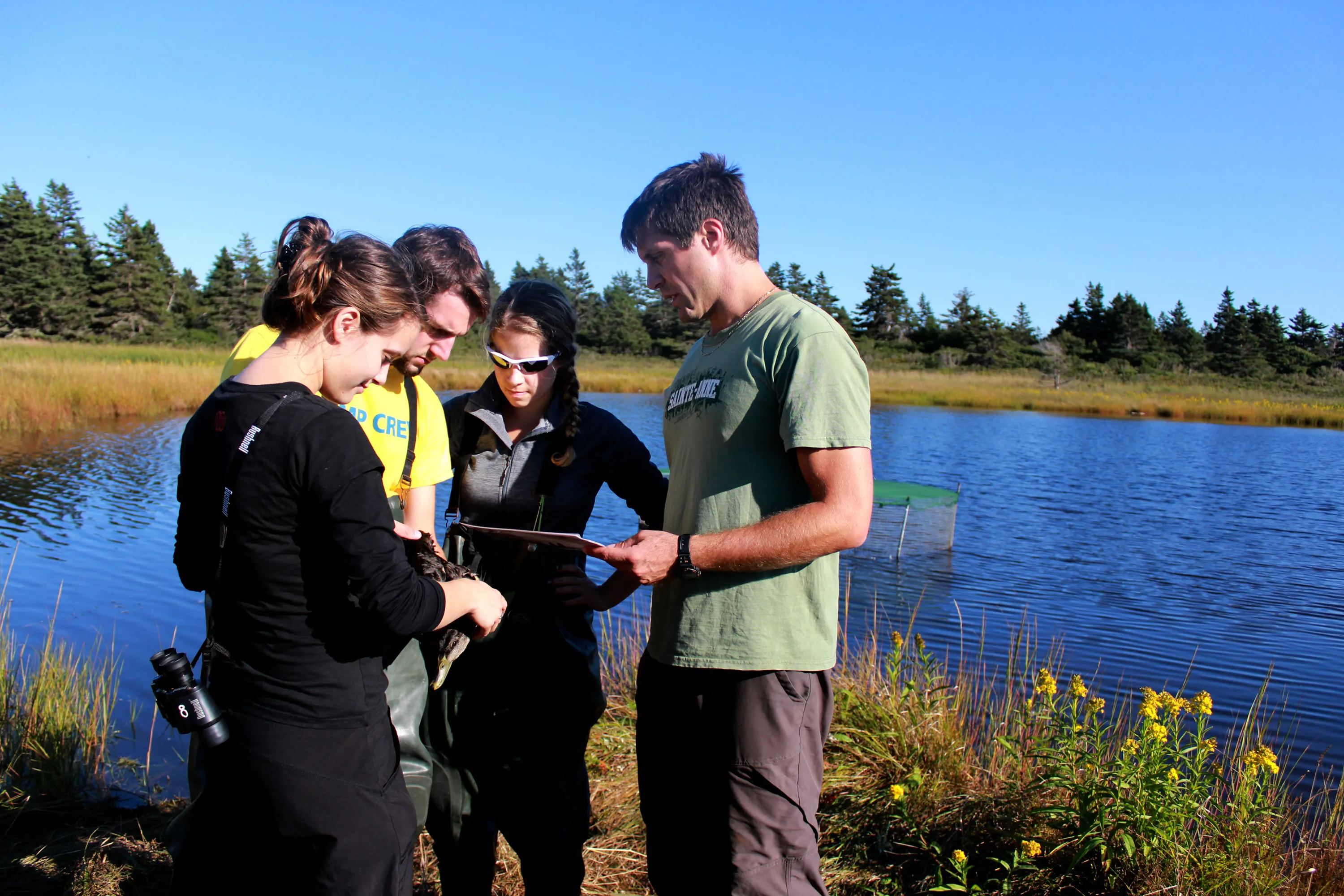 Sainte Anne university students by a lake