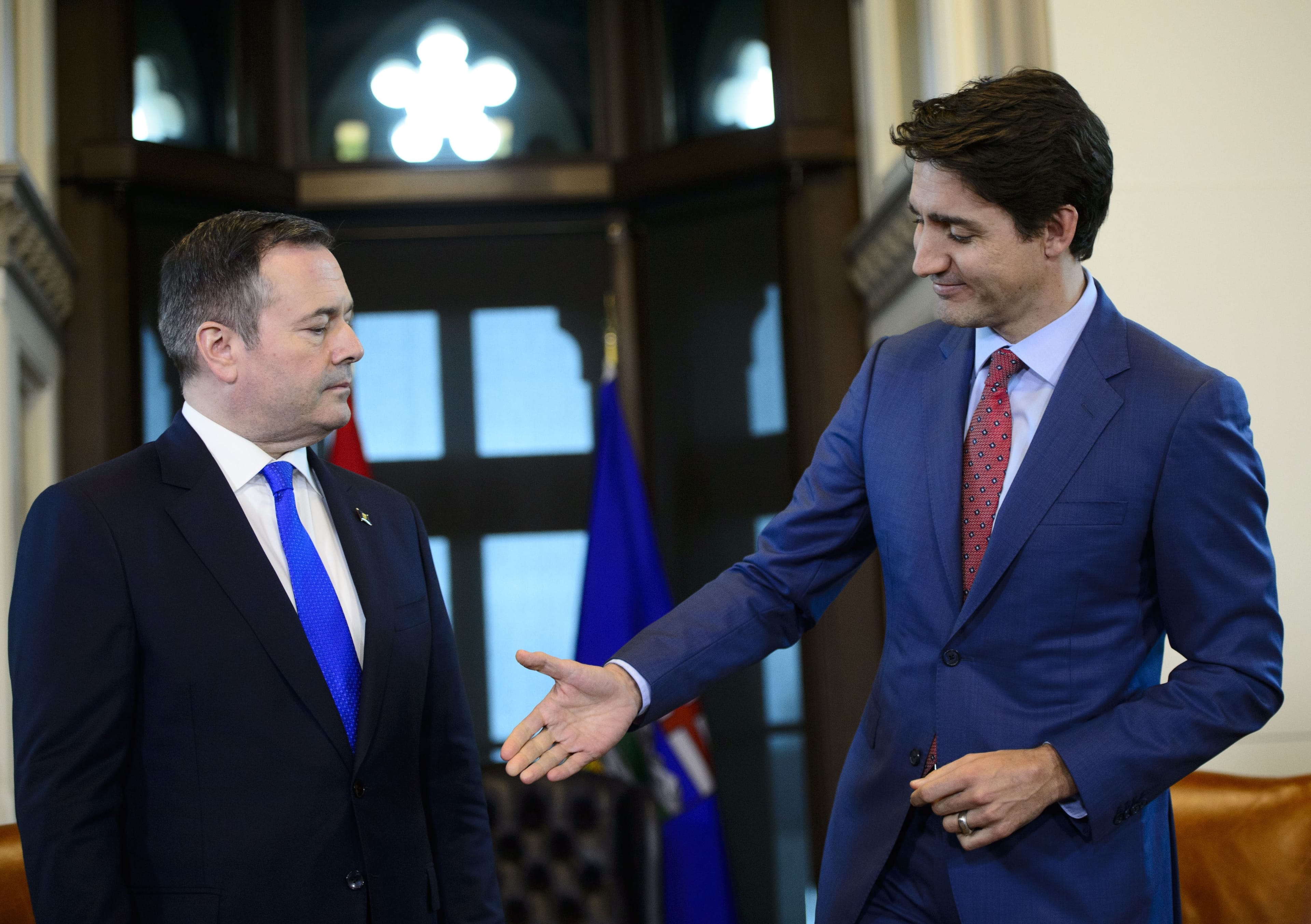 Prime Minister Justin Trudeau offers his hand to Alberta Premier Jason Kenney on Thursday (Sean Kilpatrick/CP)