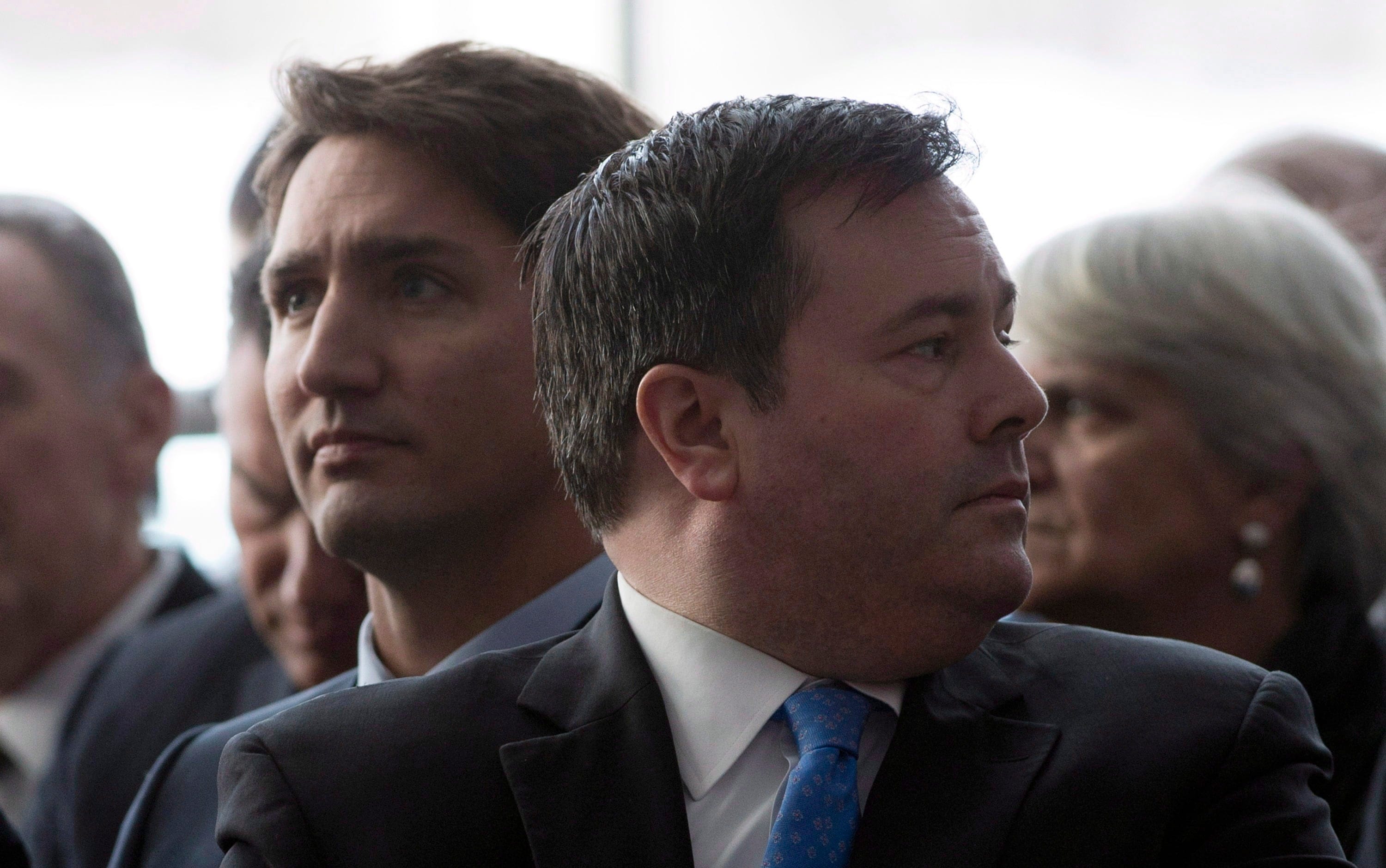 Jason Kenney sits beside Justin Trudeau on Jan. 27, 2015 in Ottawa. (CP/Adrian Wyld)