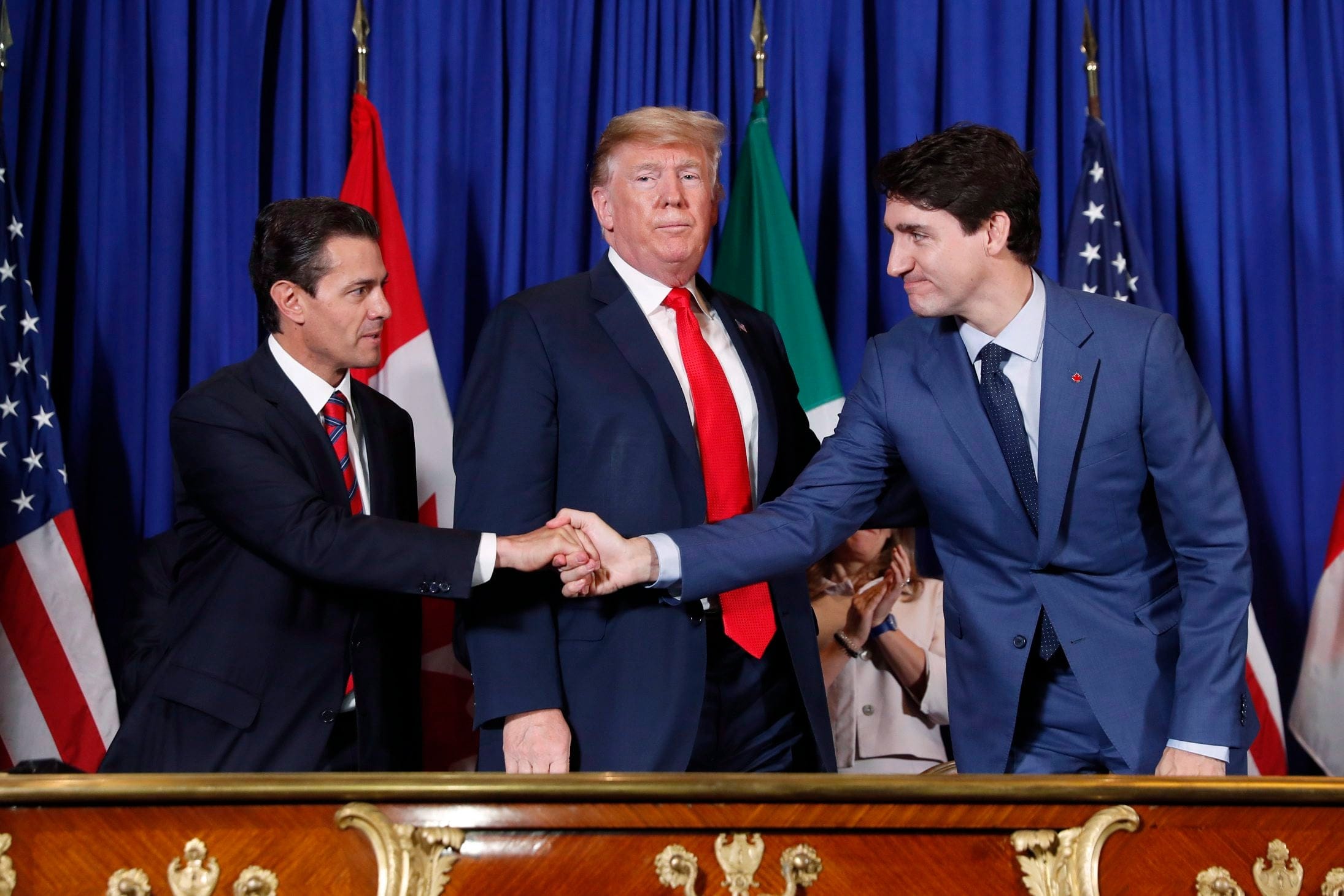 Trump, Trudeau and former Mexican president Enrique Pena Nieto, left, participate in the USMCA signing ceremony in Buenos Aires in November (Pablo Martinez Monsivais/AP)