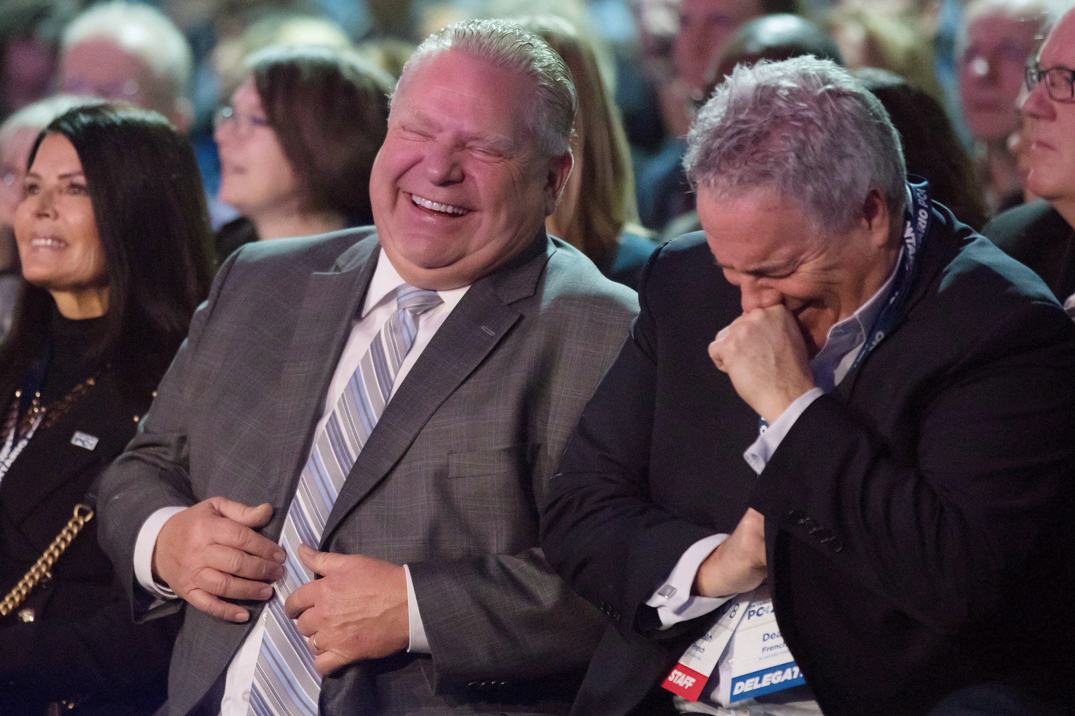 Ford and his chief of staff Dean French share a joke as they wait to hear Scheer speak at the Ontario PC Convention in Toronto on Nov. 17, 2018. (Chris Young/CP)