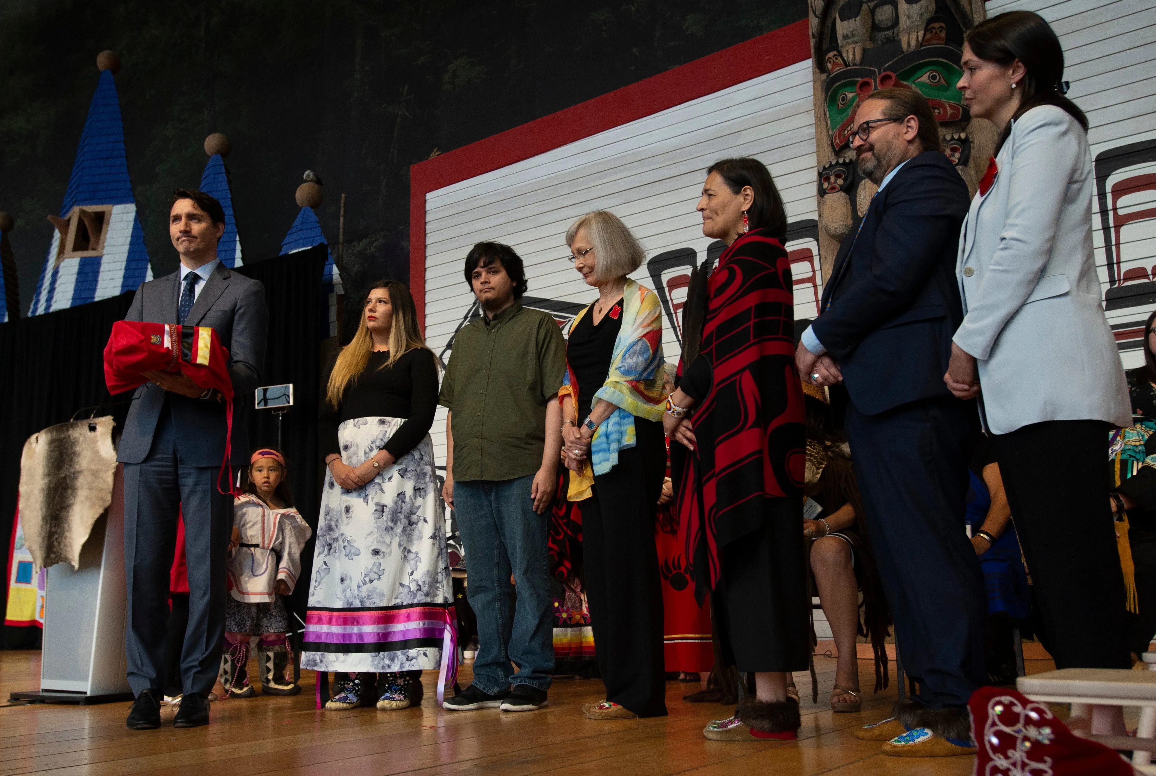 Trudeau holds a copy of the report presented to him by the commissioners of the national inquiry in Gatineau, Que., on June 3, 2019. (THE CANADIAN PRESS/Adrian Wyld)