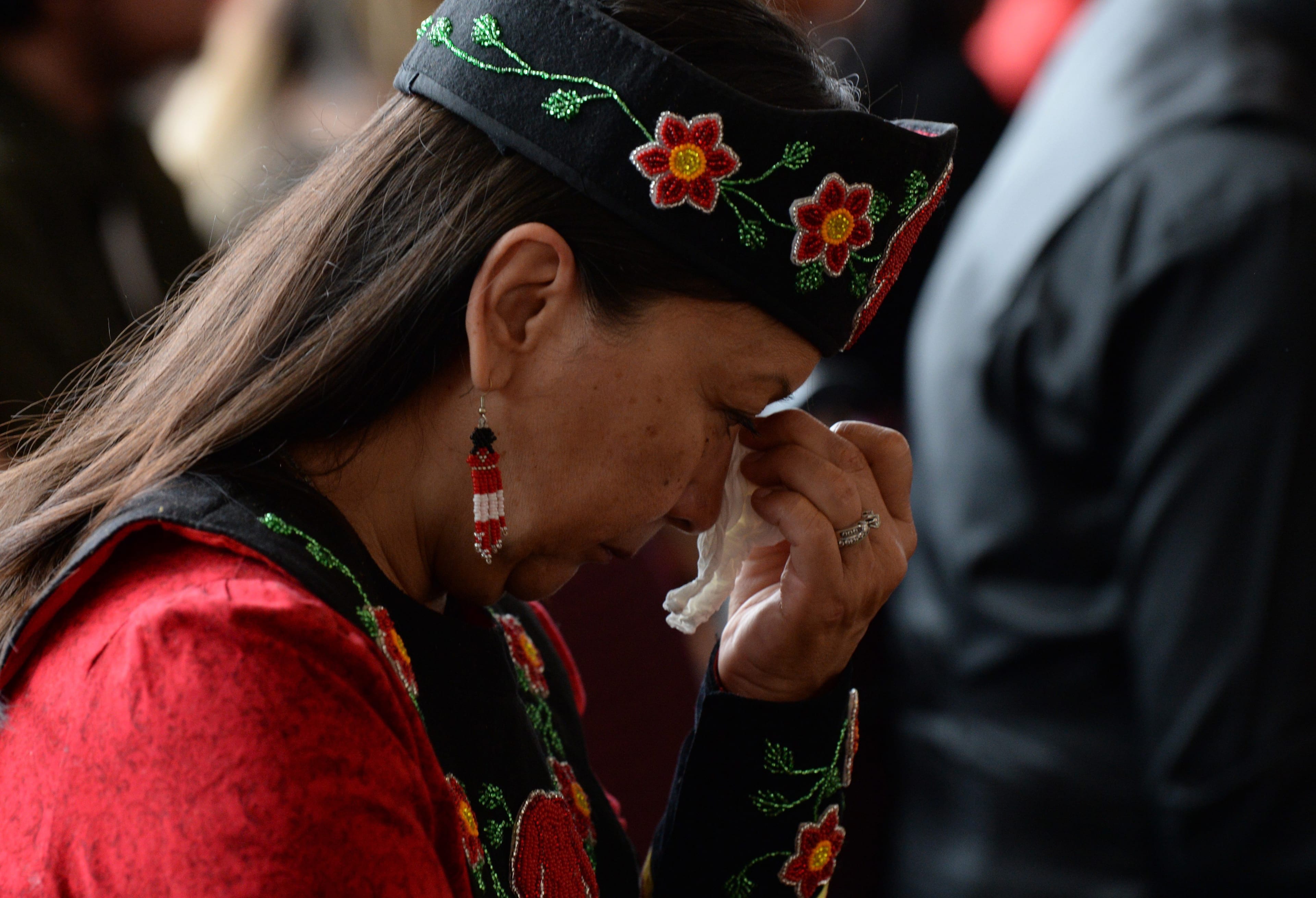 A woman listens to speakers during ceremonies marking the release of the MMIWG final report in Gatineau on June 3, 2019. (THE CANADIAN PRESS/Adrian Wyld)
