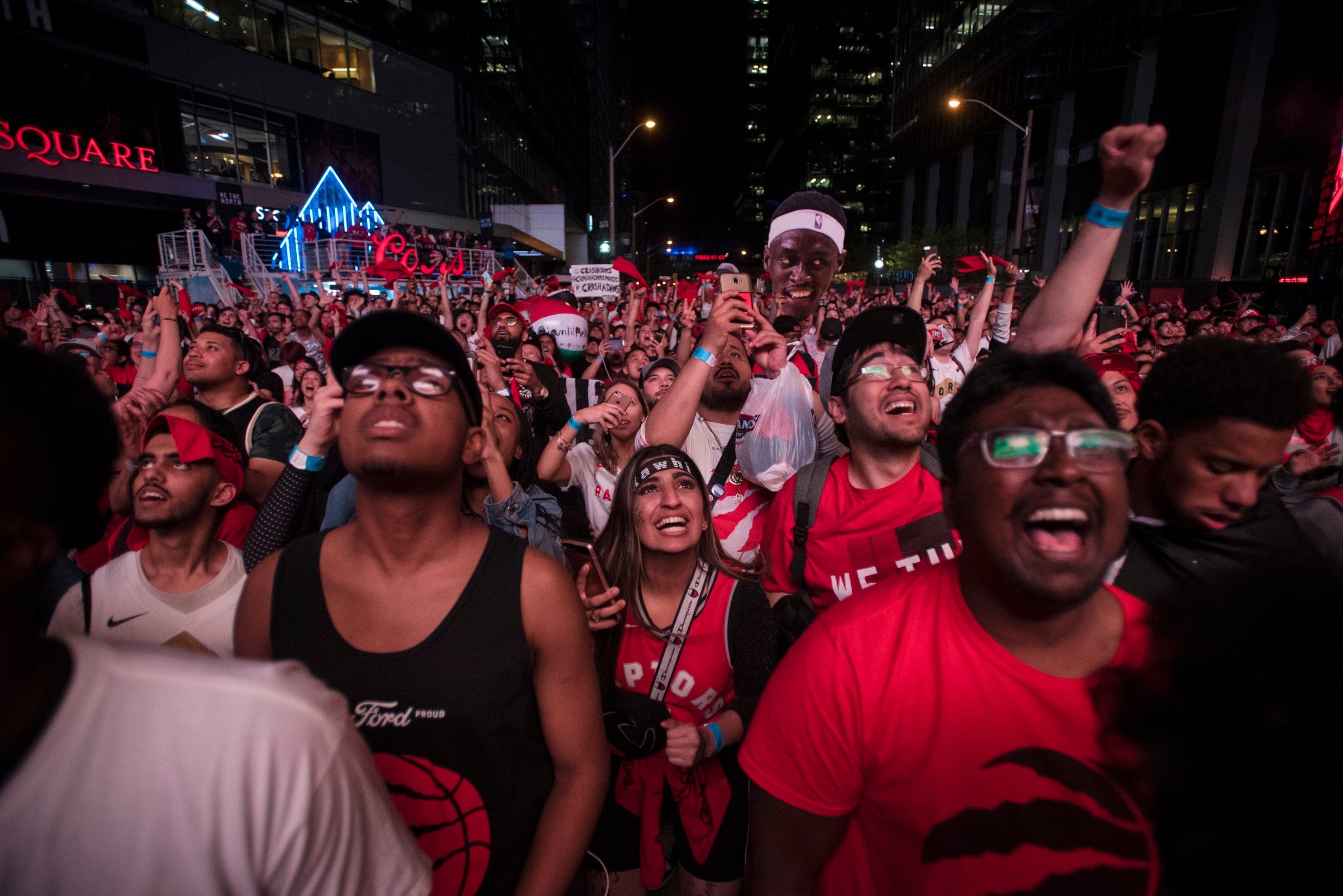 Fans celebrate in 'Jurassic Park' outside of Scotiabank Arena in Toronto on June 7, 2019. (THE CANADIAN PRESS/ Tijana Martin)