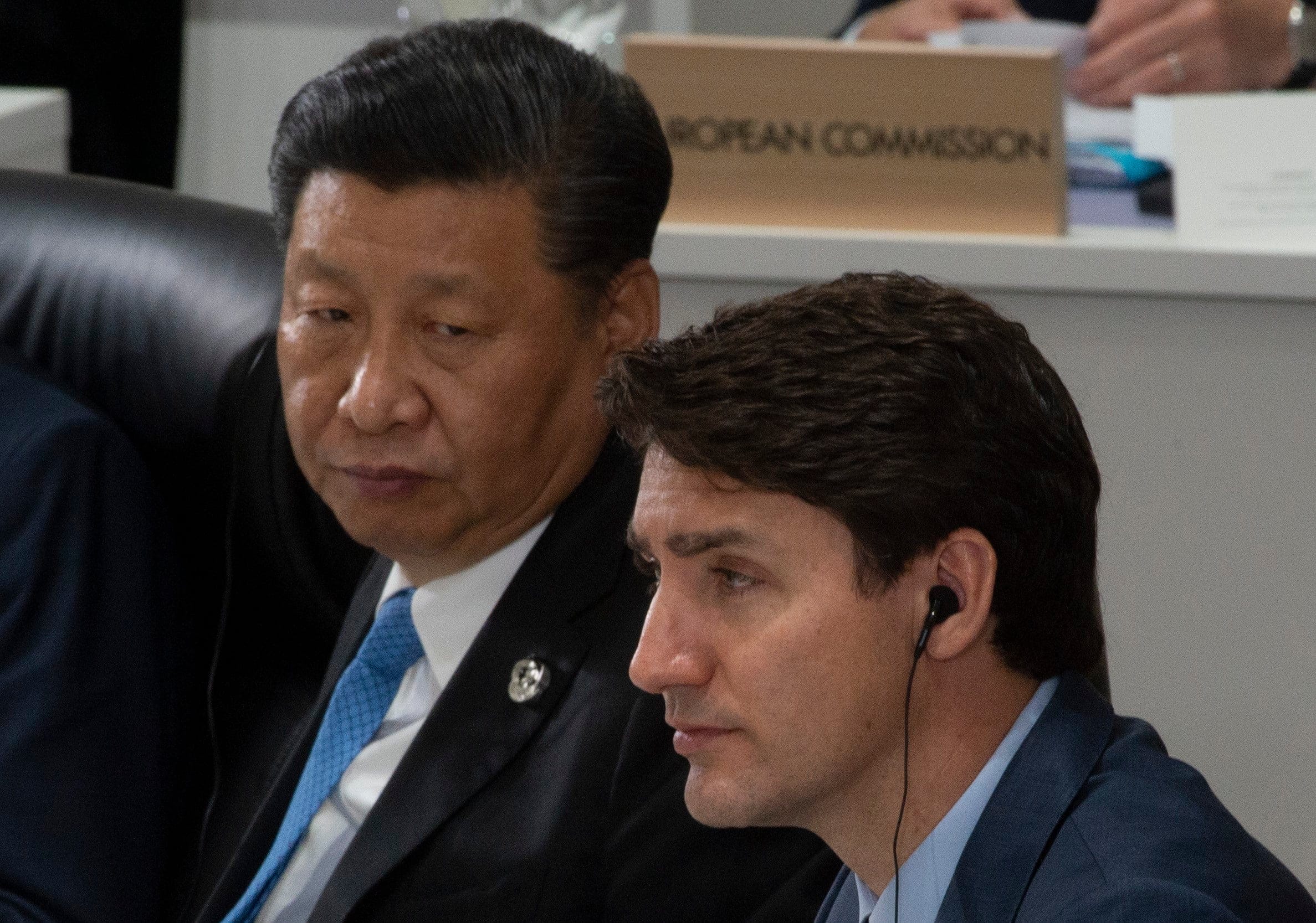 Prime Minister Justin Trudeau and Chinese President Xi Jinping listen to opening remarks at the G20 Summit in Osaka, Japan, on June 28, 2019. (Adrian Wyld/CP)