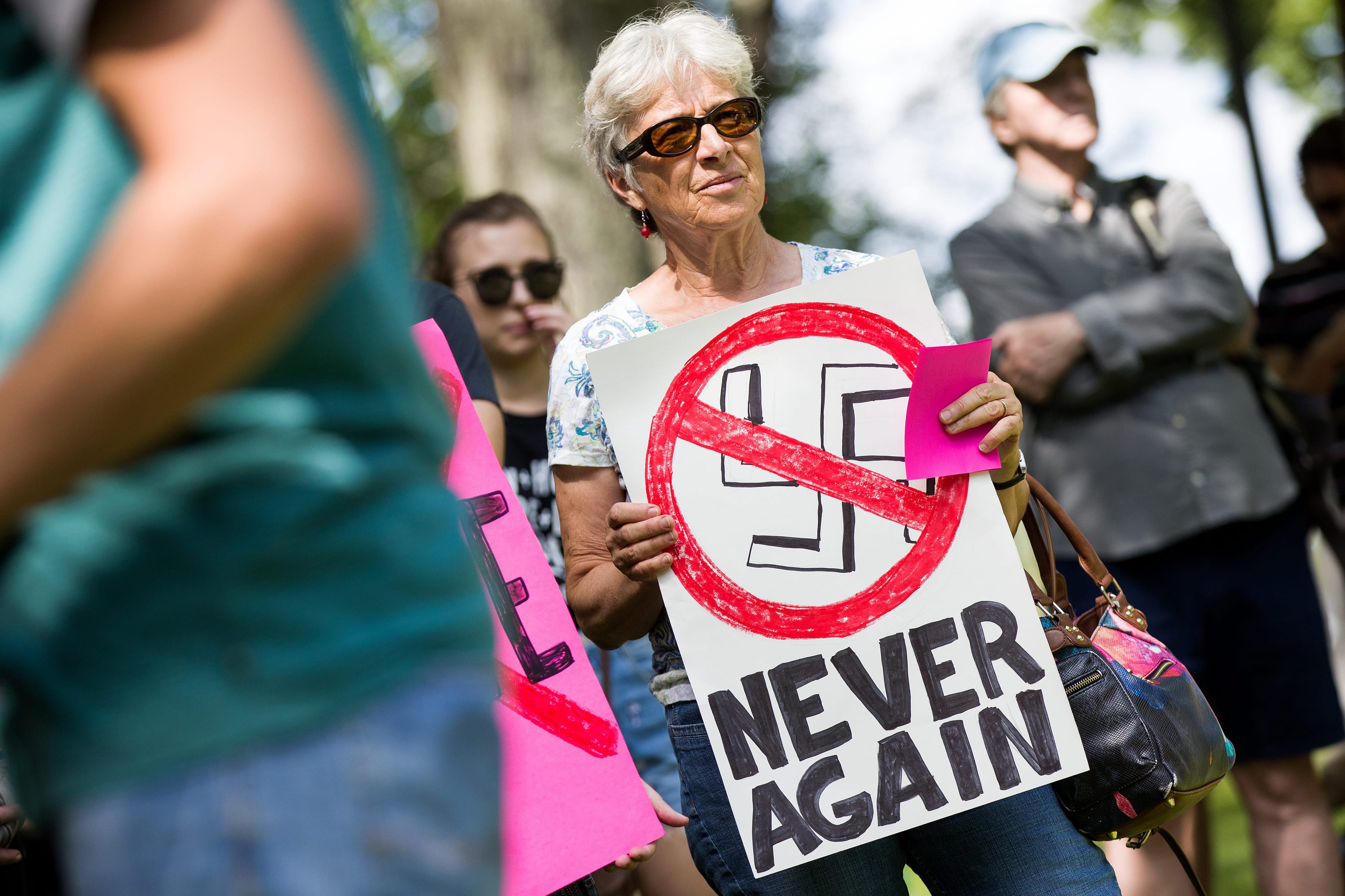 A woman hold anti-Nazi sign during an anti-racism rally in Kingston, Ont., on Aug. 19, 2017. (Lars Hagberg/CP)
