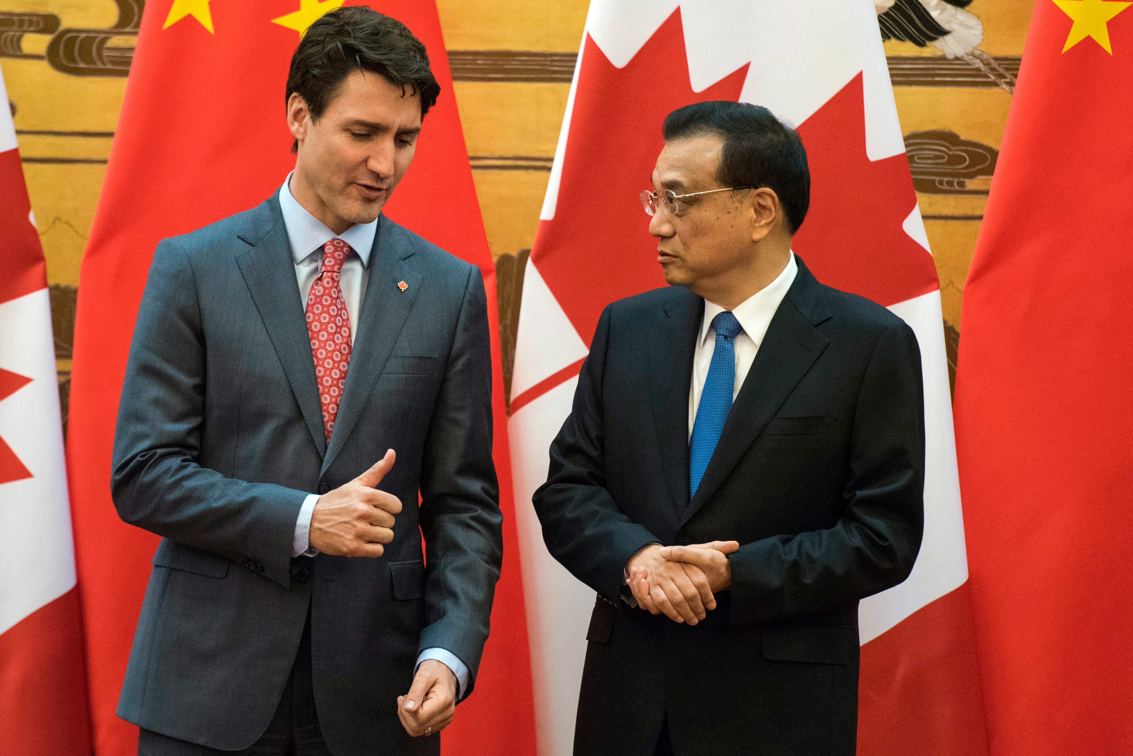 Canadian Prime Minister Justin Trudeau, left, and Chinese Premier Li Keqiang speak during a signing ceremony at the Great Hall of the People in Beijing Monday, Dec. 4, 2017. (Fred Dufour/Pool Photo via AP)