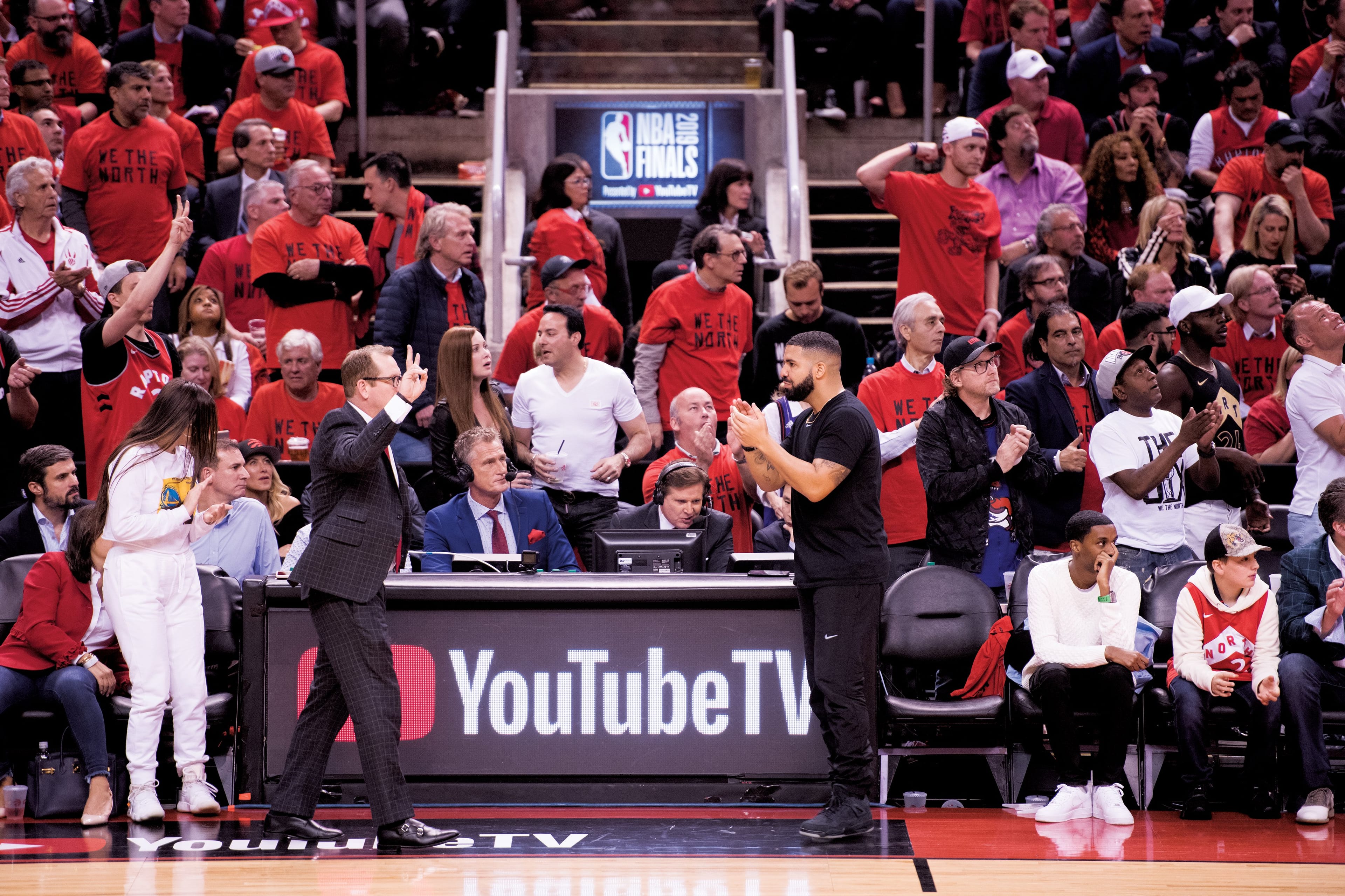 Devlin reviews the tape during a stoppage in play while Drake patrols the sidelines (Photograph by Jalani Morgan)
