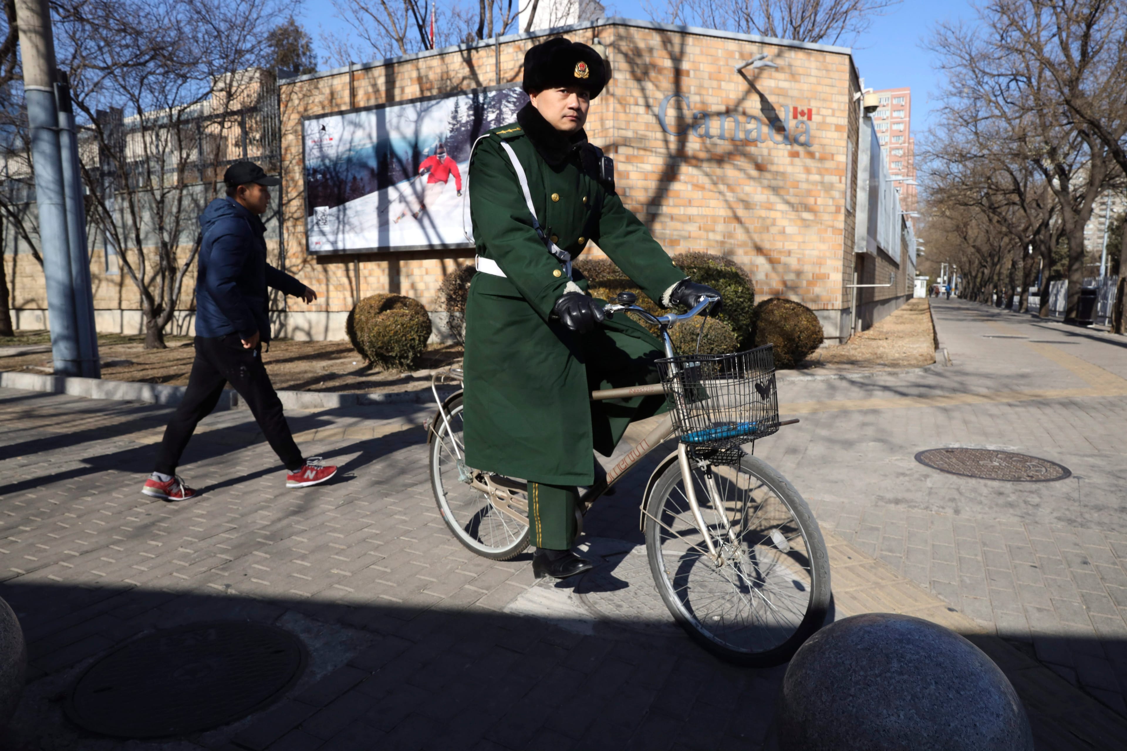 A Chinese paramilitary policeman rides past the Canadian embassy in Beijing, China, Wednesday, Jan. 16, 2019. (Ng Han Guan/AP)
