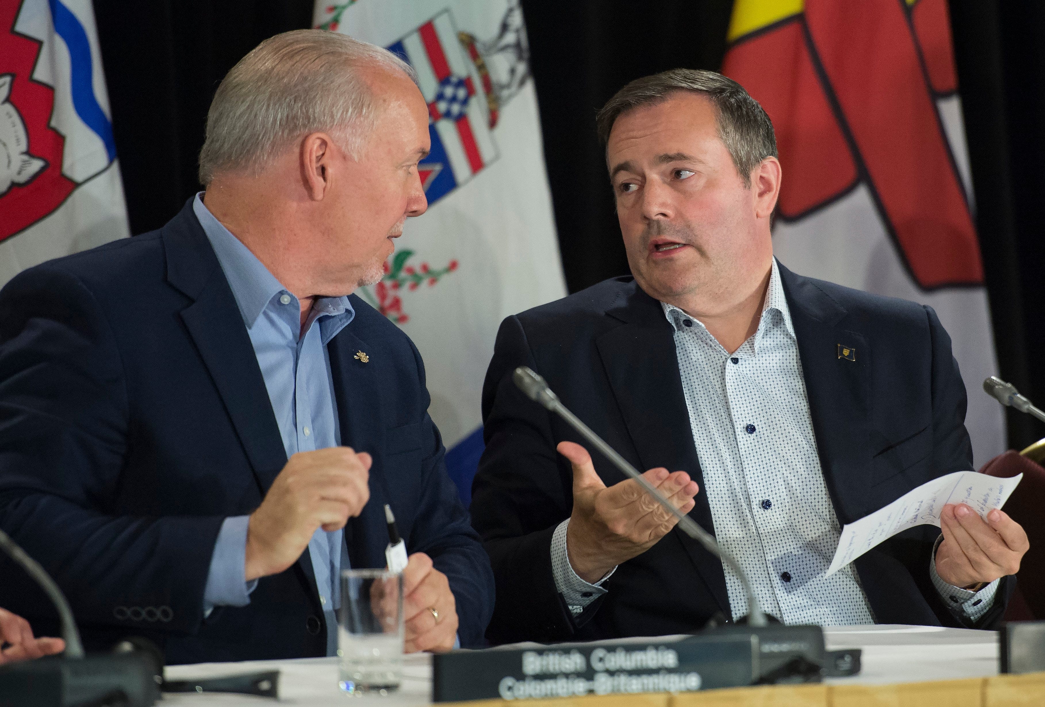 B.C. Premier John Horgan speaks with his Alberta counterpart, Jason Kenney, after the closing news conference of the first ministers' meeting Saskatoon, (Jonathan Hayward/CP)