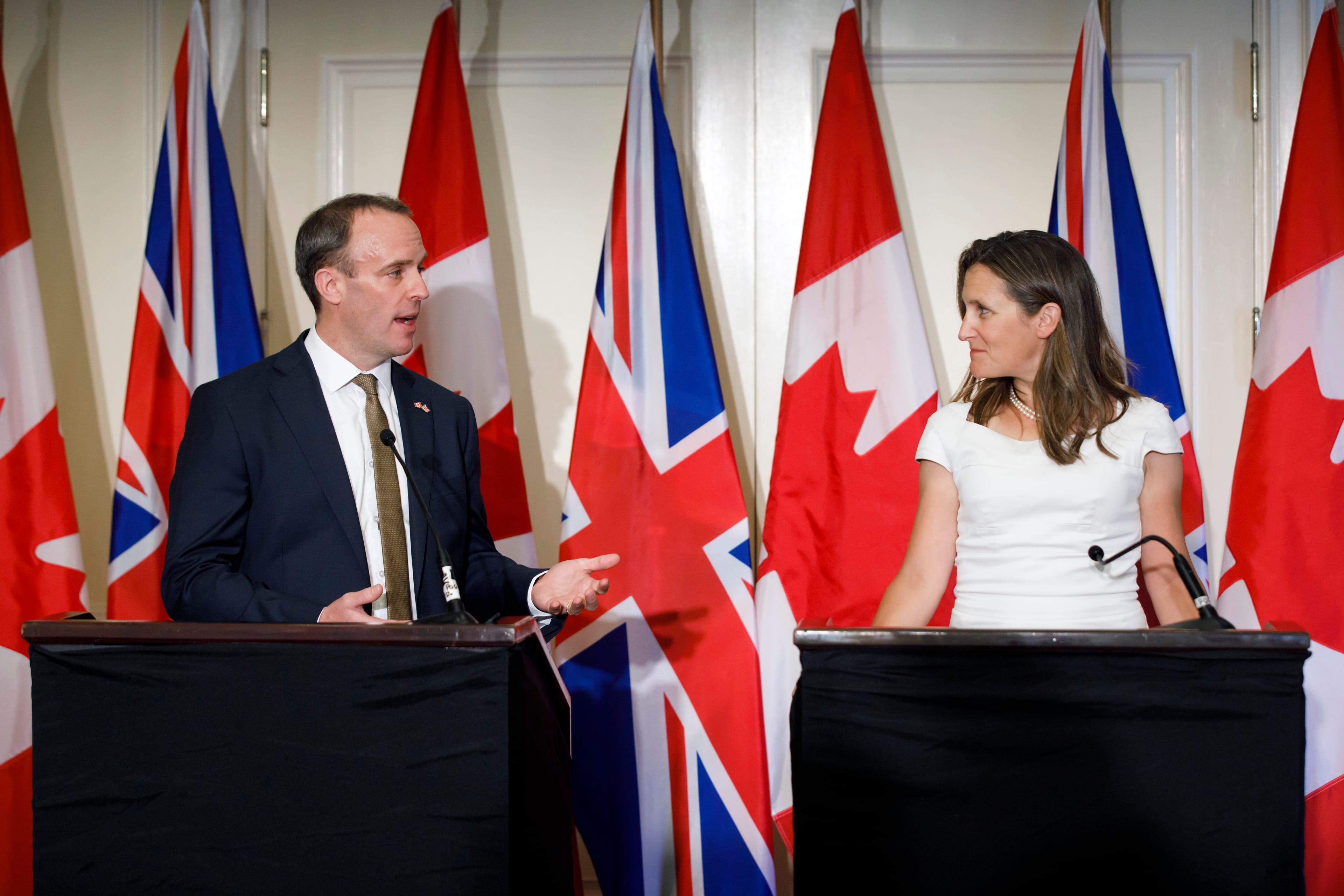 Freeland glances at Raab as he speaks during a press conference following a bilateral meeting in Toronto on Aug. 6, 2019 (THE CANADIAN PRESS/Cole Burston)