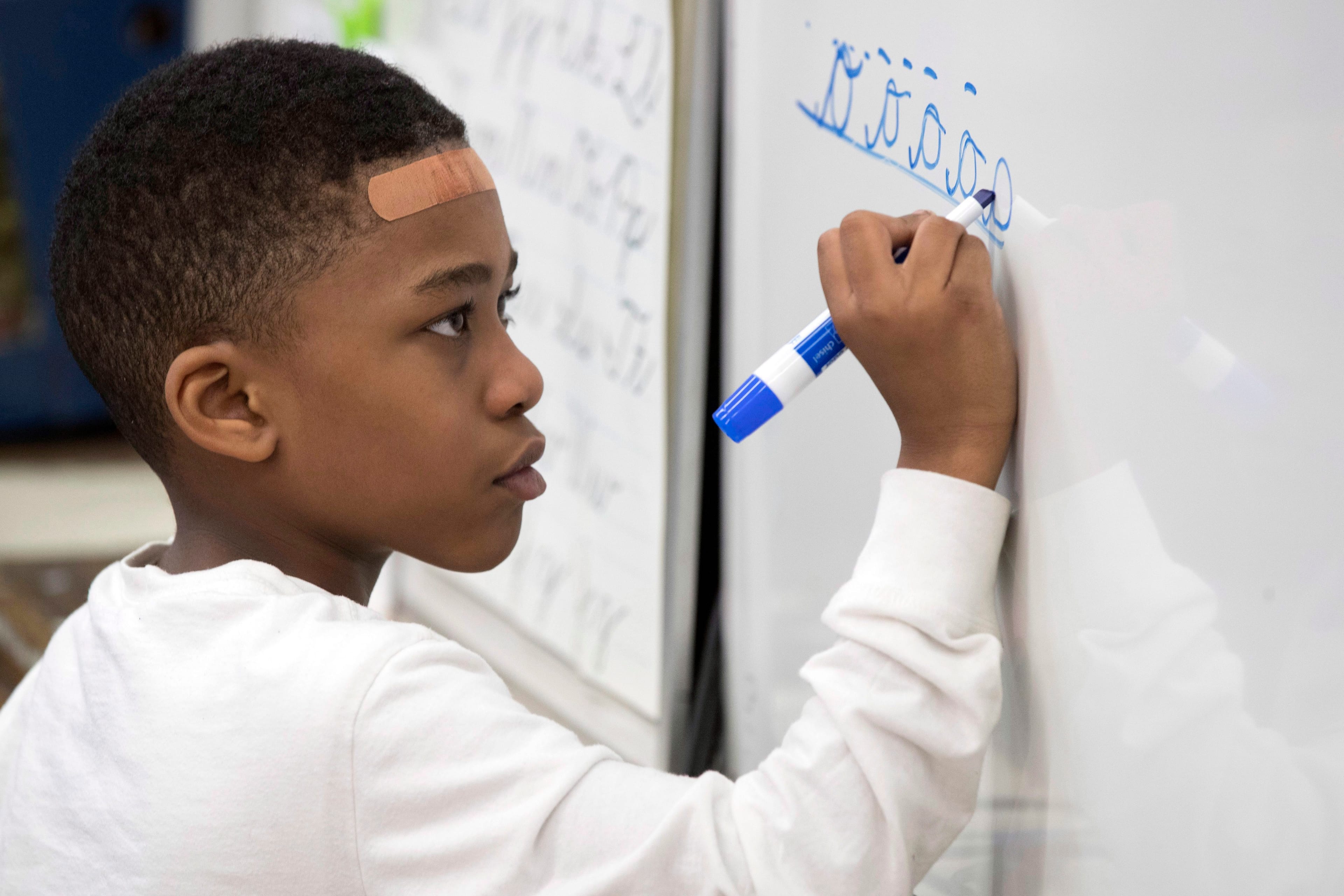 On Mar. 1, 2017, photo, a third-grader practices his cursive handwriting at P.S. 166 in the Queens borough of New York. Cursive writing is looping back into style in schools. Last fall, the 1.1 million-student New York City schools encouraged the teaching of cursive to students as young as the third grade. (AP Photo/Mary Altaffer)