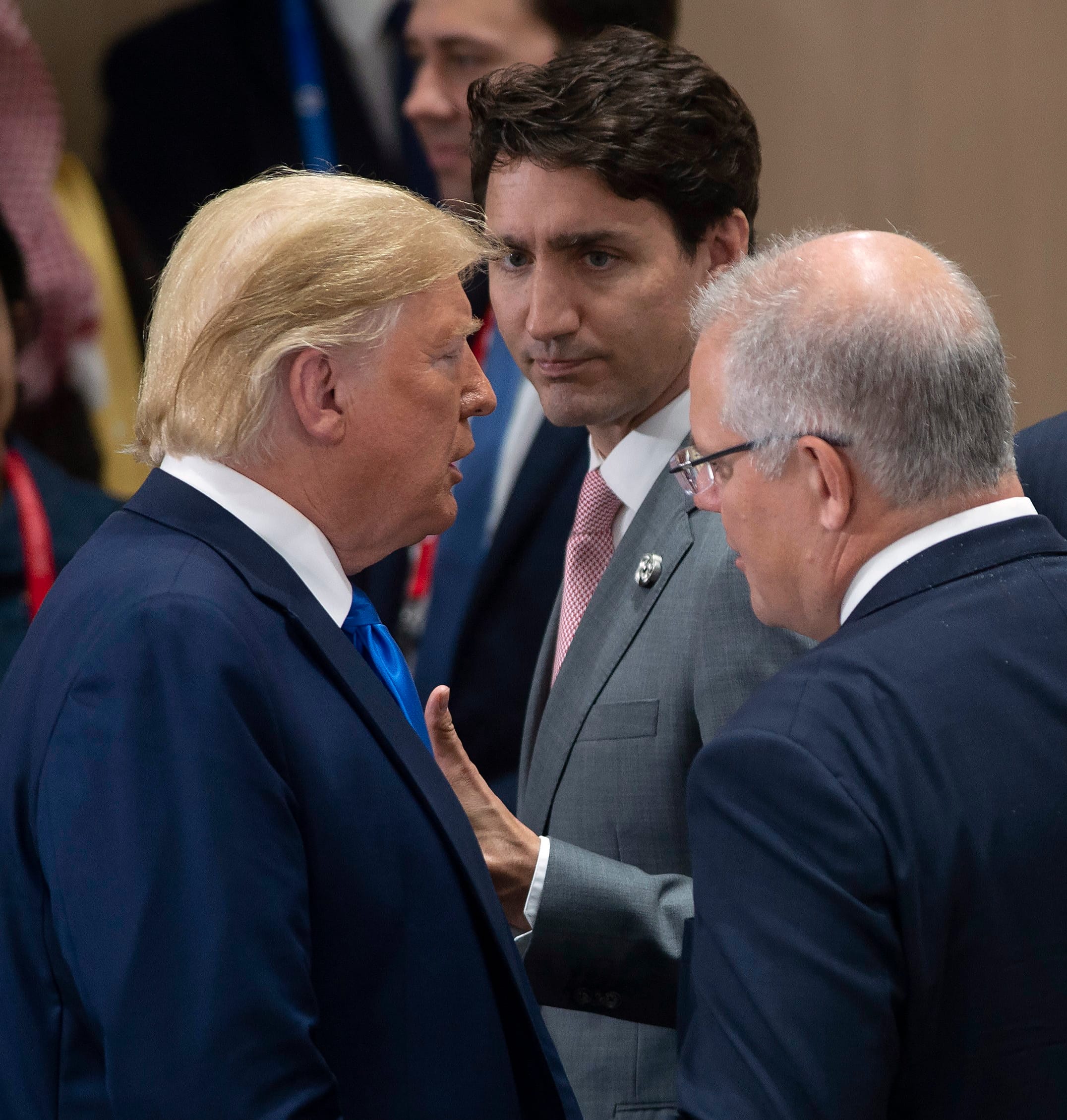 Canadian Prime Minister Justin Trudeau, centre, gives a thumbs up as he talks with United States President Donald Trump before a plenary session at the G20 Summit in Osaka, Japan, Saturday June 29, 2019. (Adrian Wyld/CP)