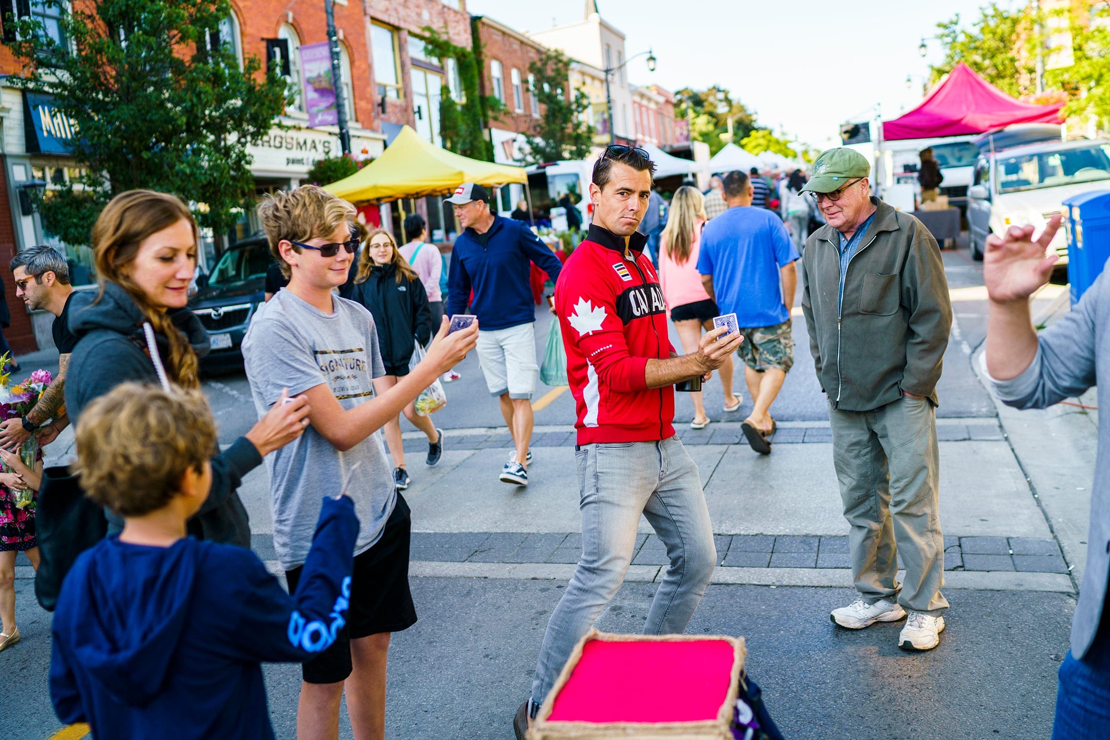 Adam van Koeverden, the federal Liberal candidate for Milton, watches a magic show at the Milton Farmers Market in August (Photograph by Mark Blinch)