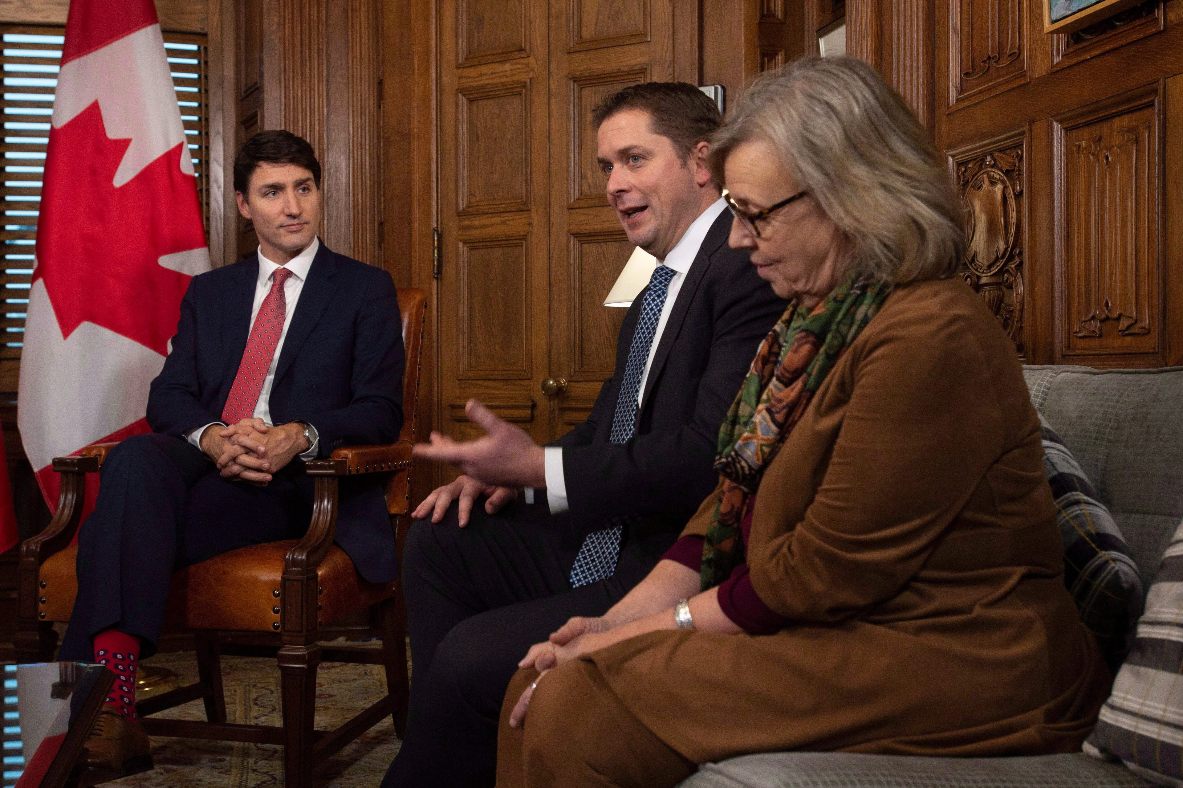 Prime Minister Justin Trudeau and Green party leader Elizabeth May listen as Leader of the Opposition Andrew Scheer delivers some opening remarks as all party leaders meet in the prime ministers office to discuss francophone issues in Ottawa. (CP/Adrian Wyld)