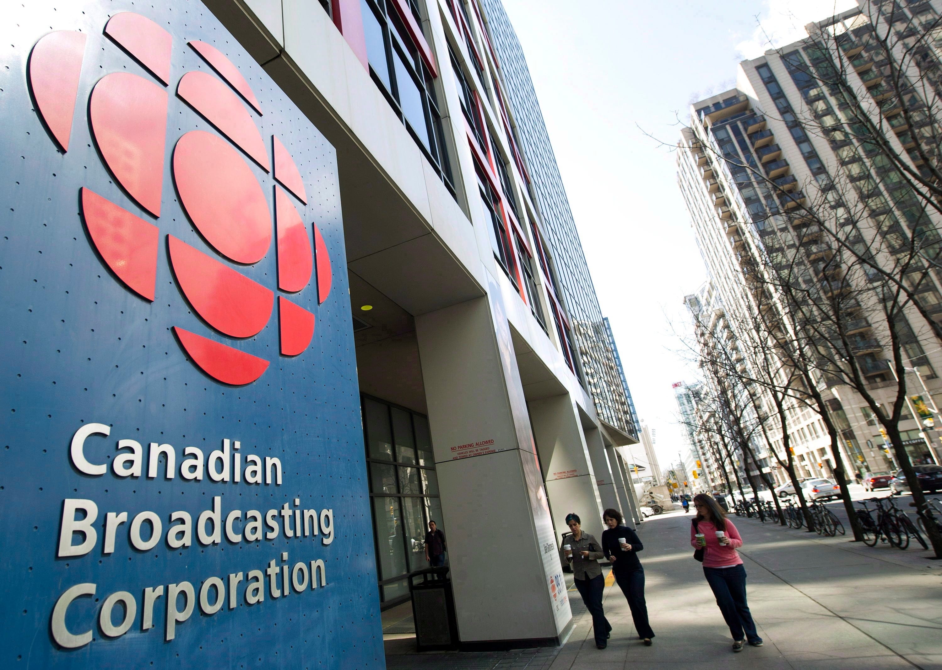 People walk into the CBC building in Toronto on April 4, 2012. (CP/Nathan Denette)