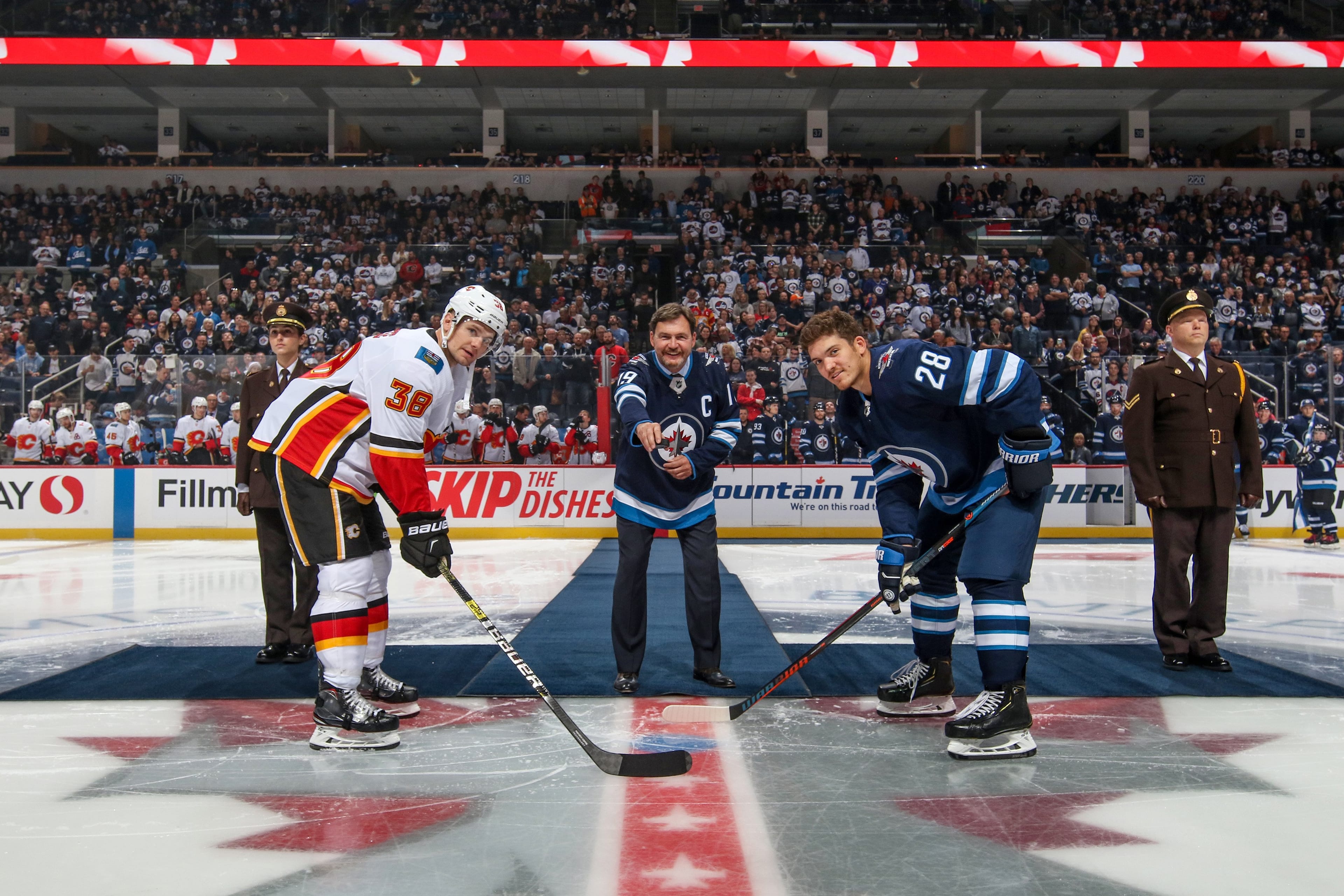 Justice Wagner (centre) during the ceremonial puck drop at the Bell MTS Place arena. (Winnipeg Jets Hockey Club/NHL Images)