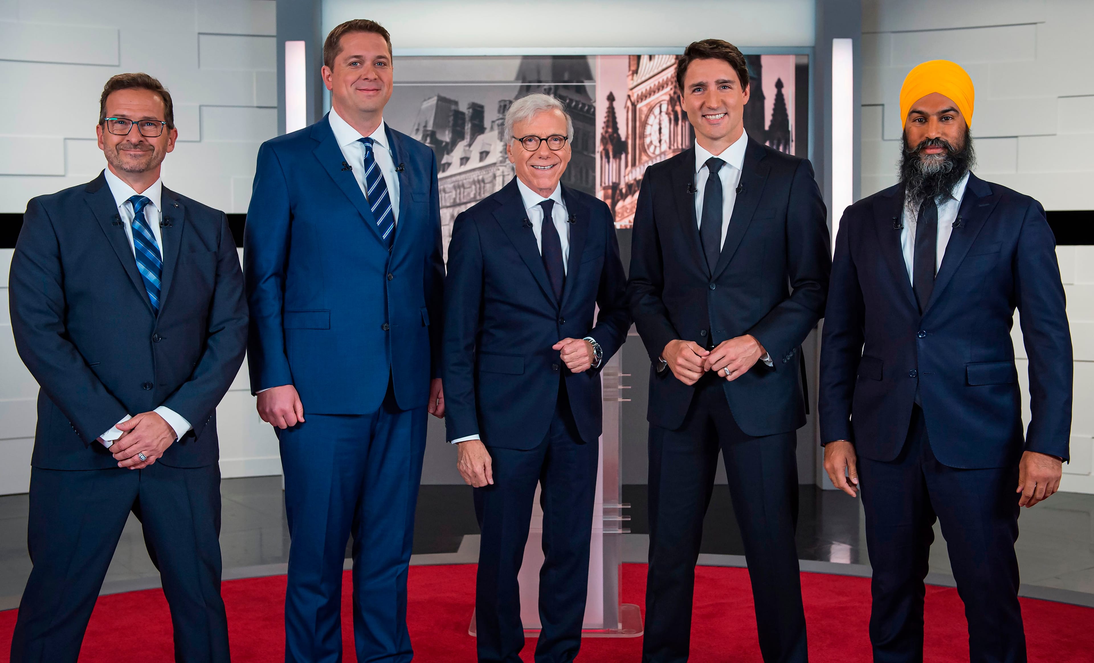 (From L) Leader of the Bloc quebecois leader Yves-François Blanchet, Conservative leader Andrew Scheer, Canadian journalist Pierre Bruneau, Liberal leader Justin Trudeau and NDP leader Jagmeet Singh pose for pictures ahead of the "Face-a-Face 2019" debate presented in the TVA studios in Montreal. (Joel Lemay/AFP/Getty Images)