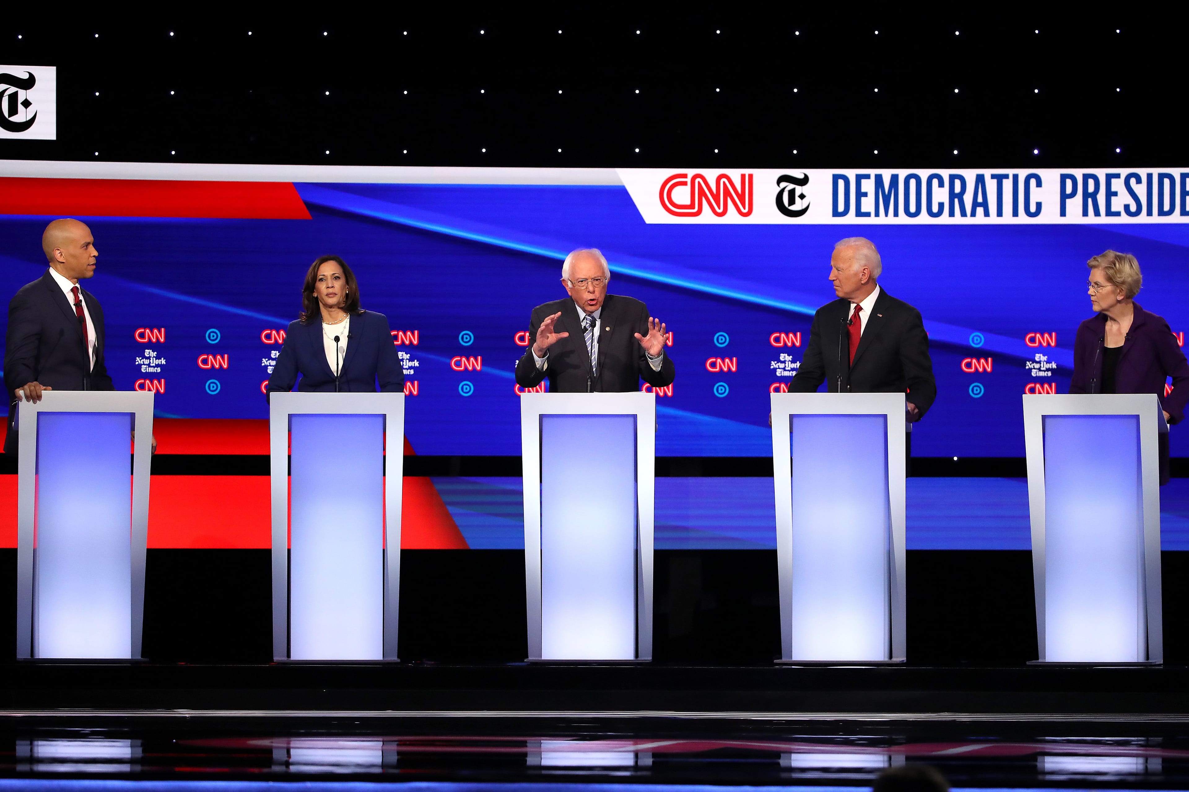 WESTERVILLE, OHIO - OCTOBER 15: Sen. Cory Booker (D-NJ), Sen. Kamala Harris (D-CA), Sen. Bernie Sanders (I-VT), former Vice President Joe Biden, and Sen. Elizabeth Warren (D-MA) interact during the Democratic Presidential Debate at Otterbein University on October 15, 2019 in Westerville, Ohio. A record 12 presidential hopefuls are participating in the debate hosted by CNN and The New York Times. (Photo by Win McNamee/Getty Images)