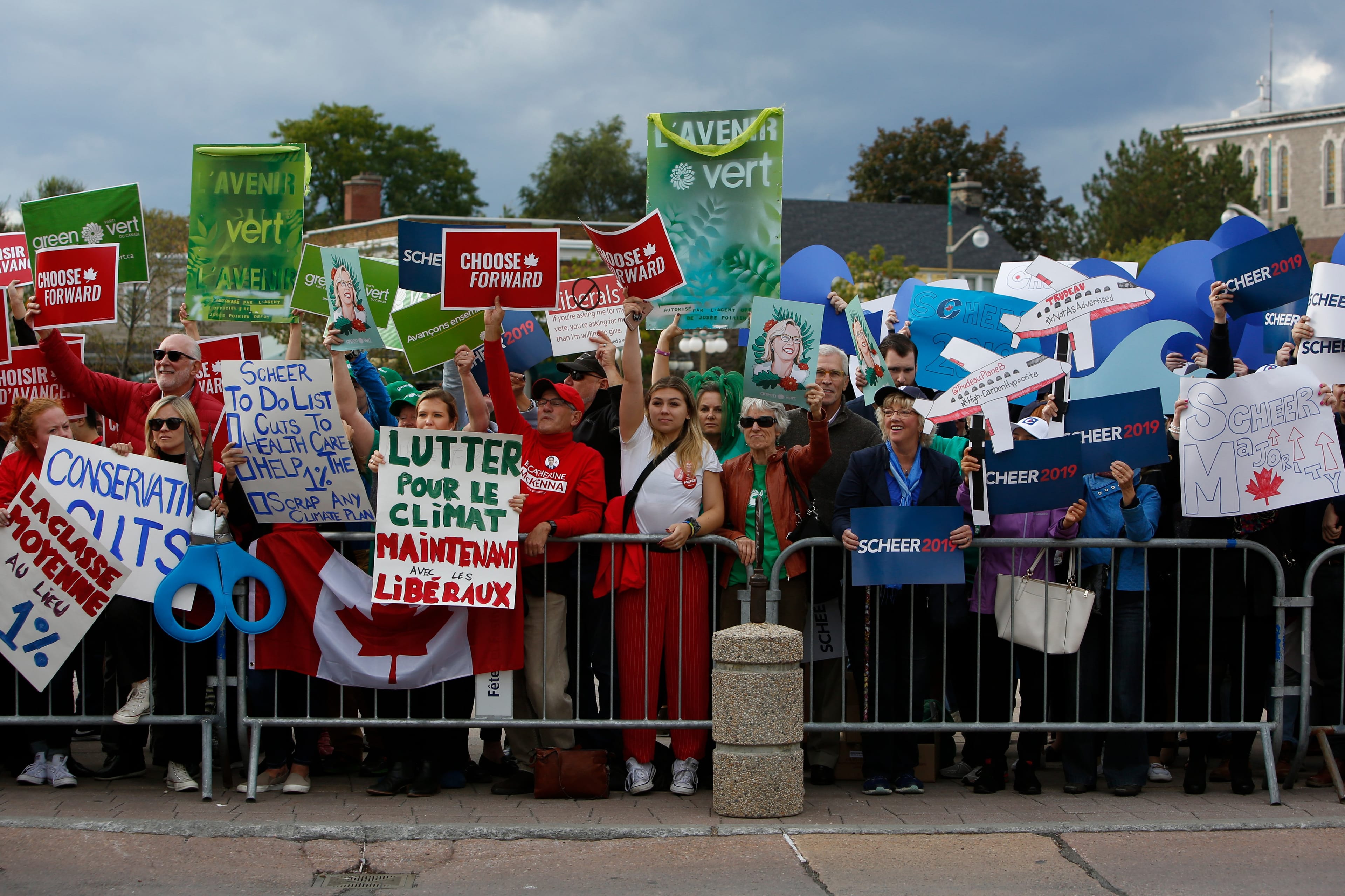 Supporters and demonstrators of various political stripes outside a federal leaders debate, an array of opposing viewpoints on display (David Kawai/Bloomberg/Getty Images)