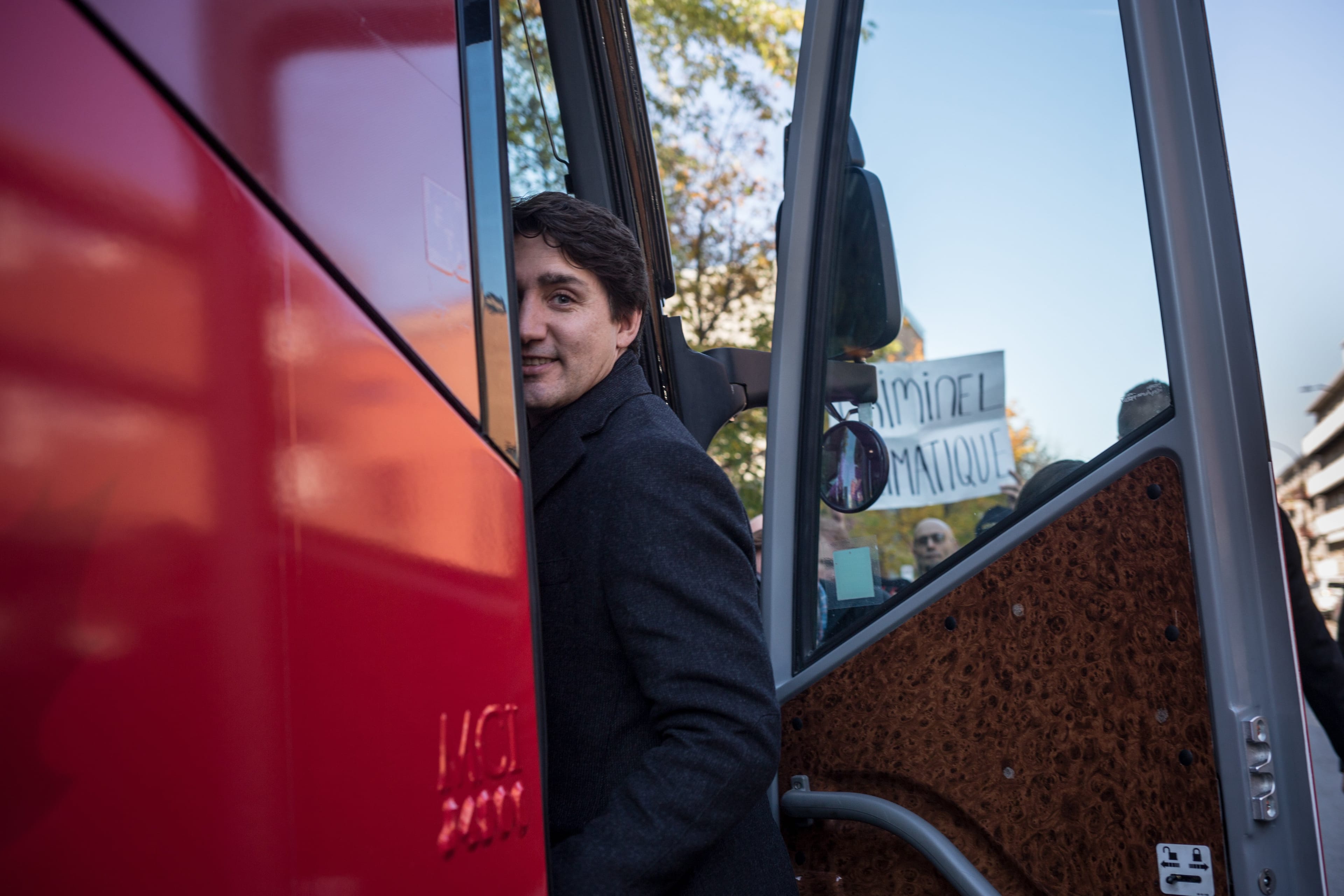 PM Justin Trudeau boards a Liberal campaign bus outside the voting station where he cast his ballot moments before. As Trudeau exited the buidling at 7378 Lajeunesse street in Montreal, a climat protester harangued him and waved a sign reading "Climate Criminal". Trudeau did not acknowledge him.