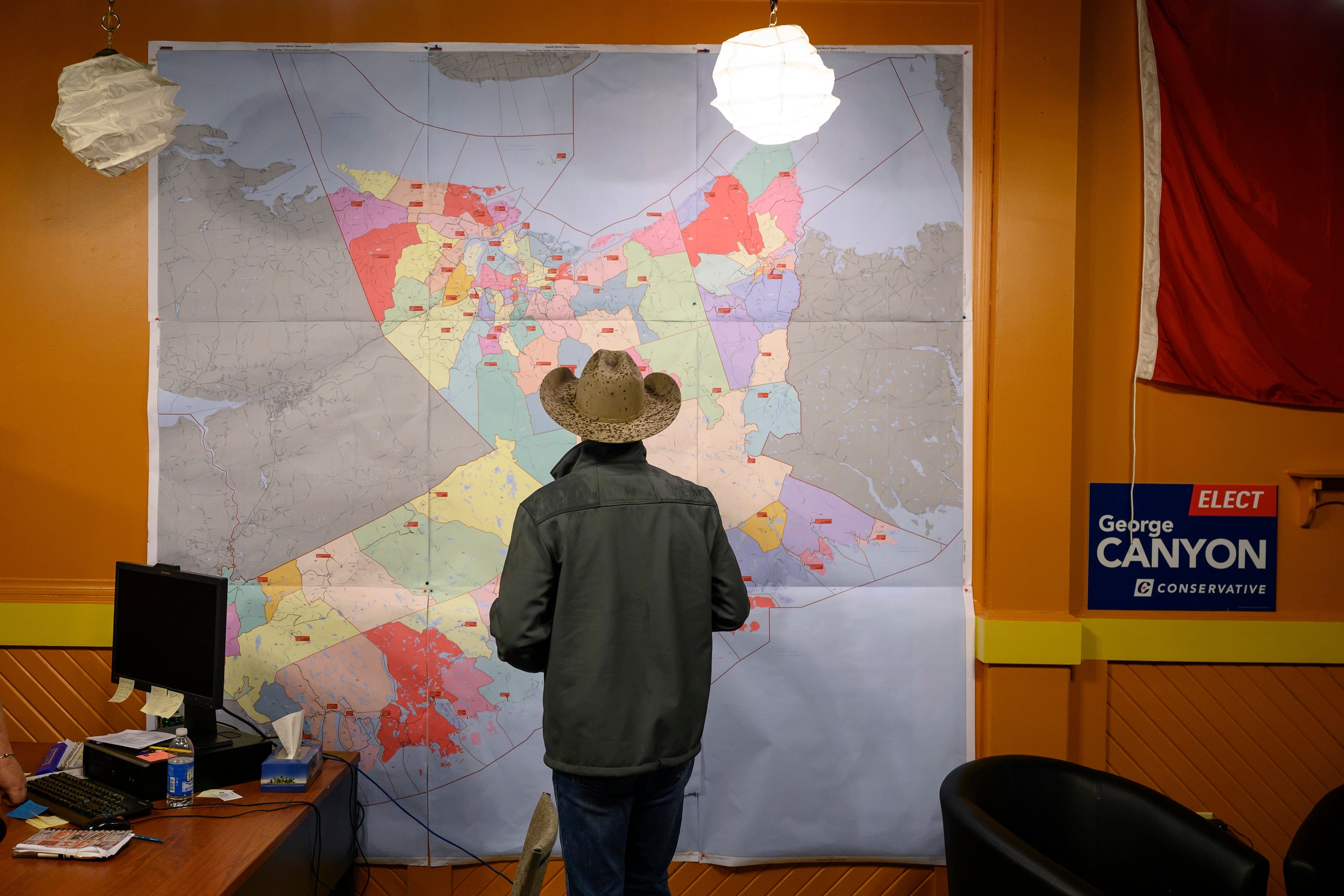 Canyon studies the Central Nova riding map at his campaign office in New Glasgow, N.S. (Photograph by Darren Calabrese)