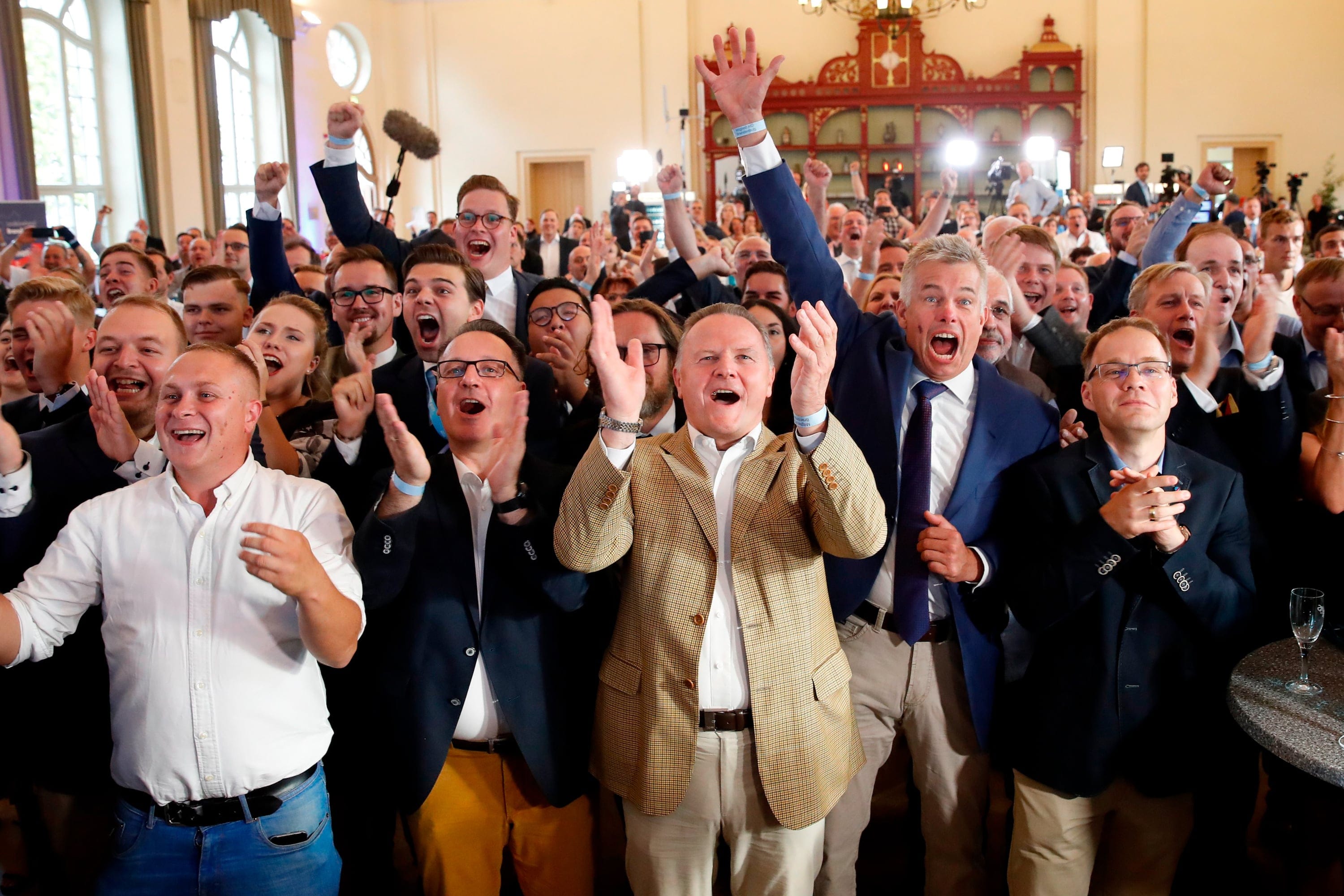Berlin's representative of the Alternative for Germany (AfD) far-right party Georg Pazderski (C) and party supporters and members react after the first exit polls following the state elections in Brandenburg and Saxony on September 1, 2019. (Odd Anderson/AFP/Getty Images)