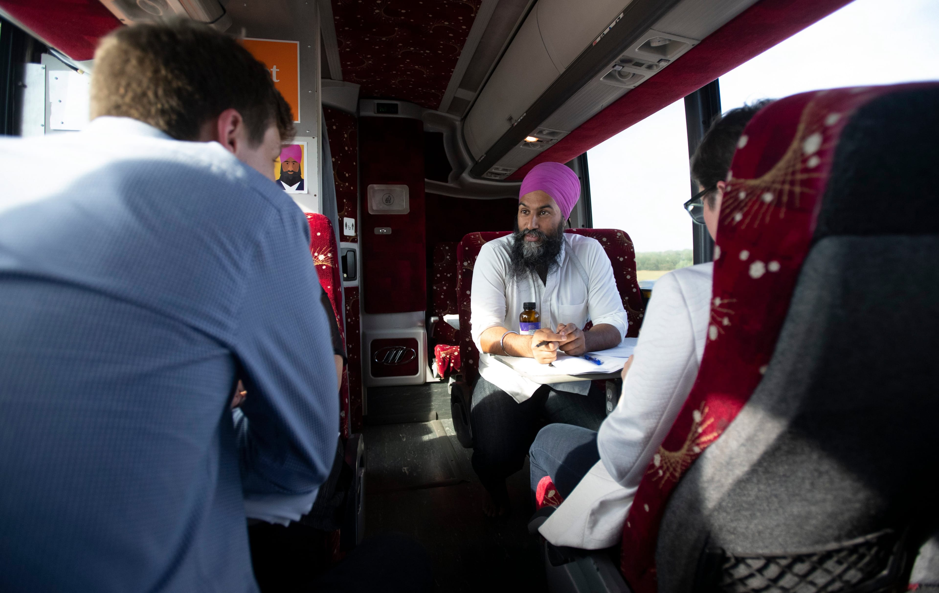 Singh, with staffers on his campaign bus,
made his way across Ontario in September (Adrian Wyld/CP)