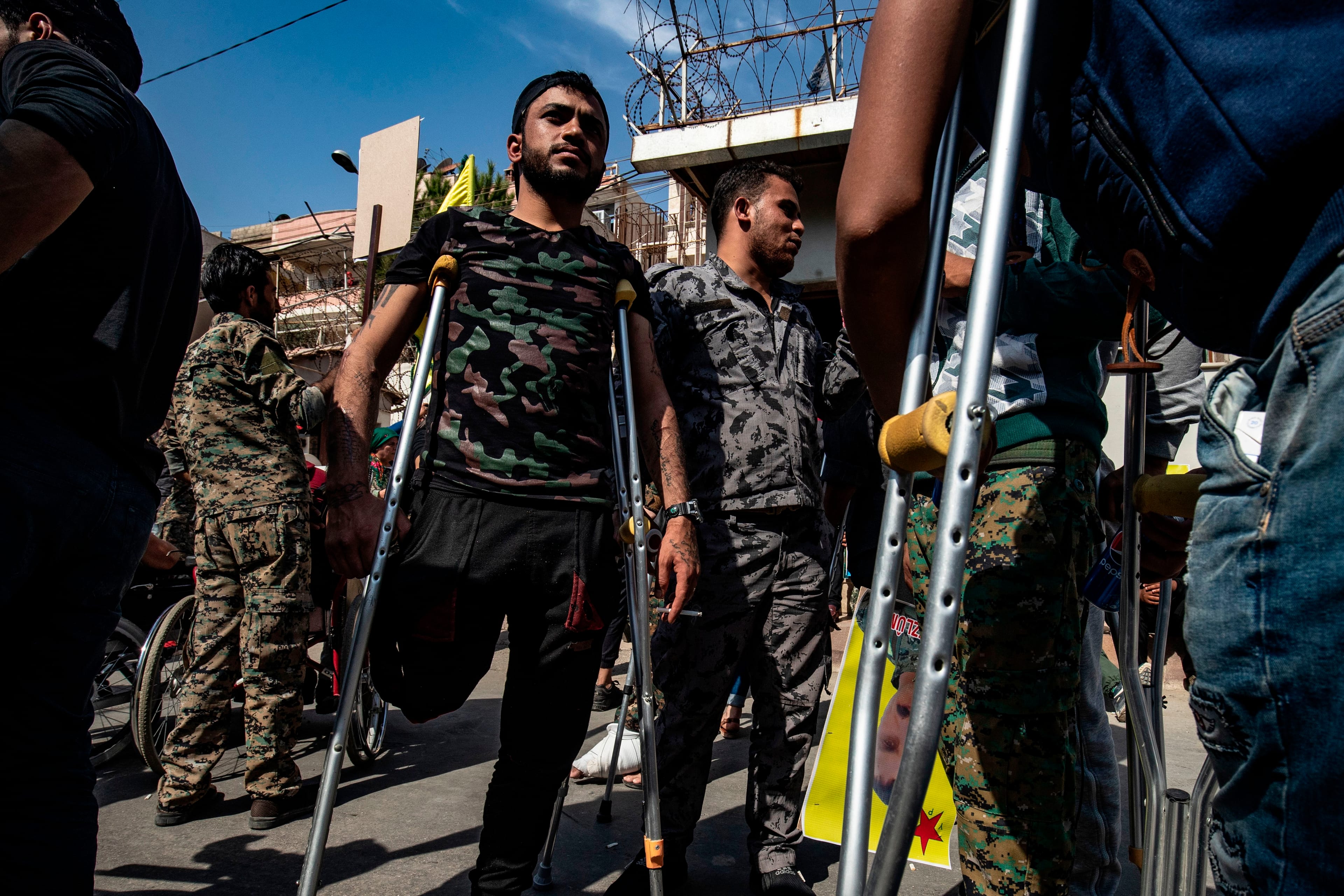 Kurdish fighters and veterans march in front of UN offices in the northern Kurdish Syrian city of Qamishli during a protest against Turkish threats in the Kurdish region (Delil Souleiman /AFP/ Getty)
