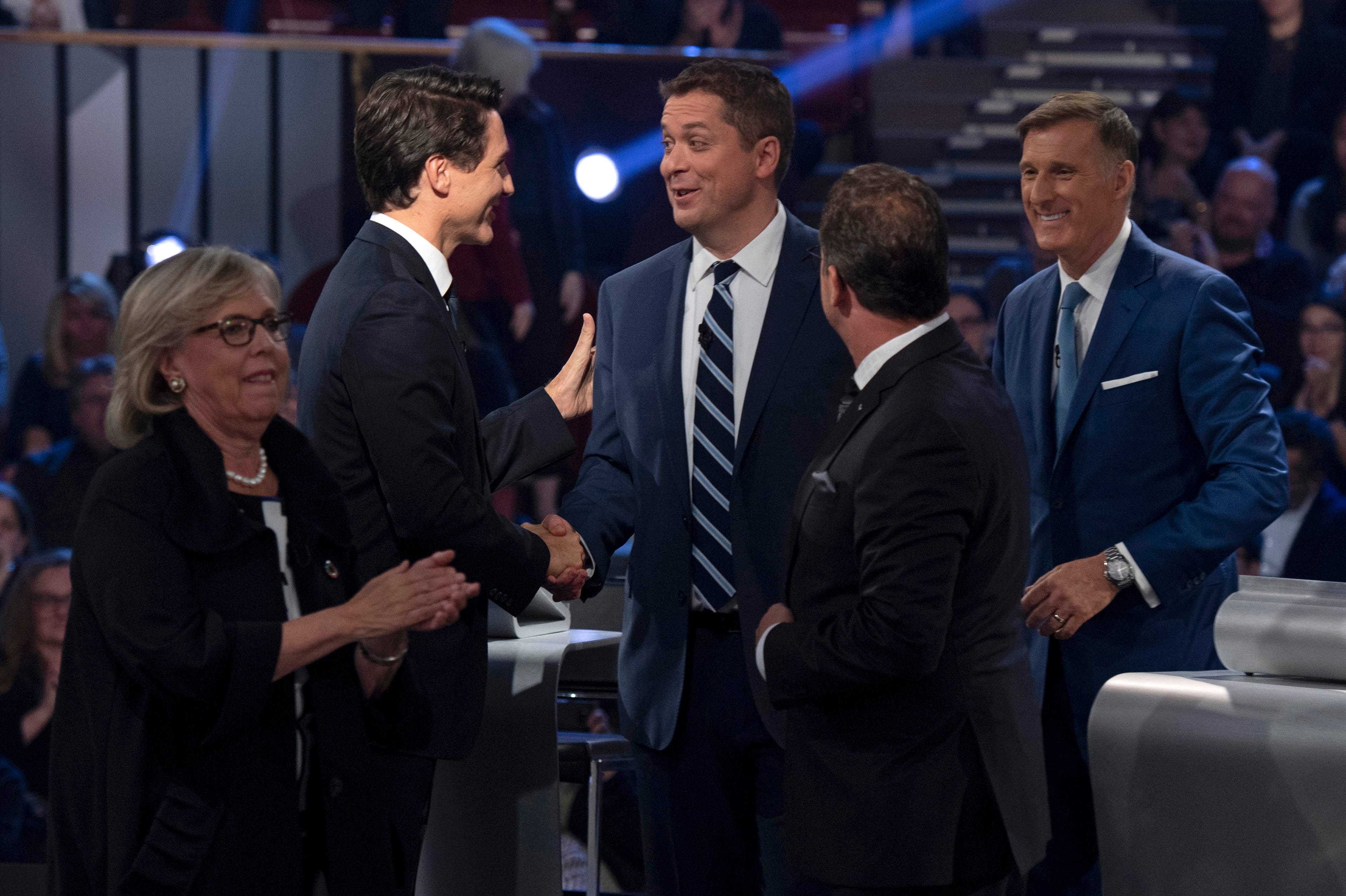 Trudeau shakes hands with Scheer as May, Blanchet and Bernier leave the stage following the federal leaders debate (Justin Tang/AFP/Getty Images)