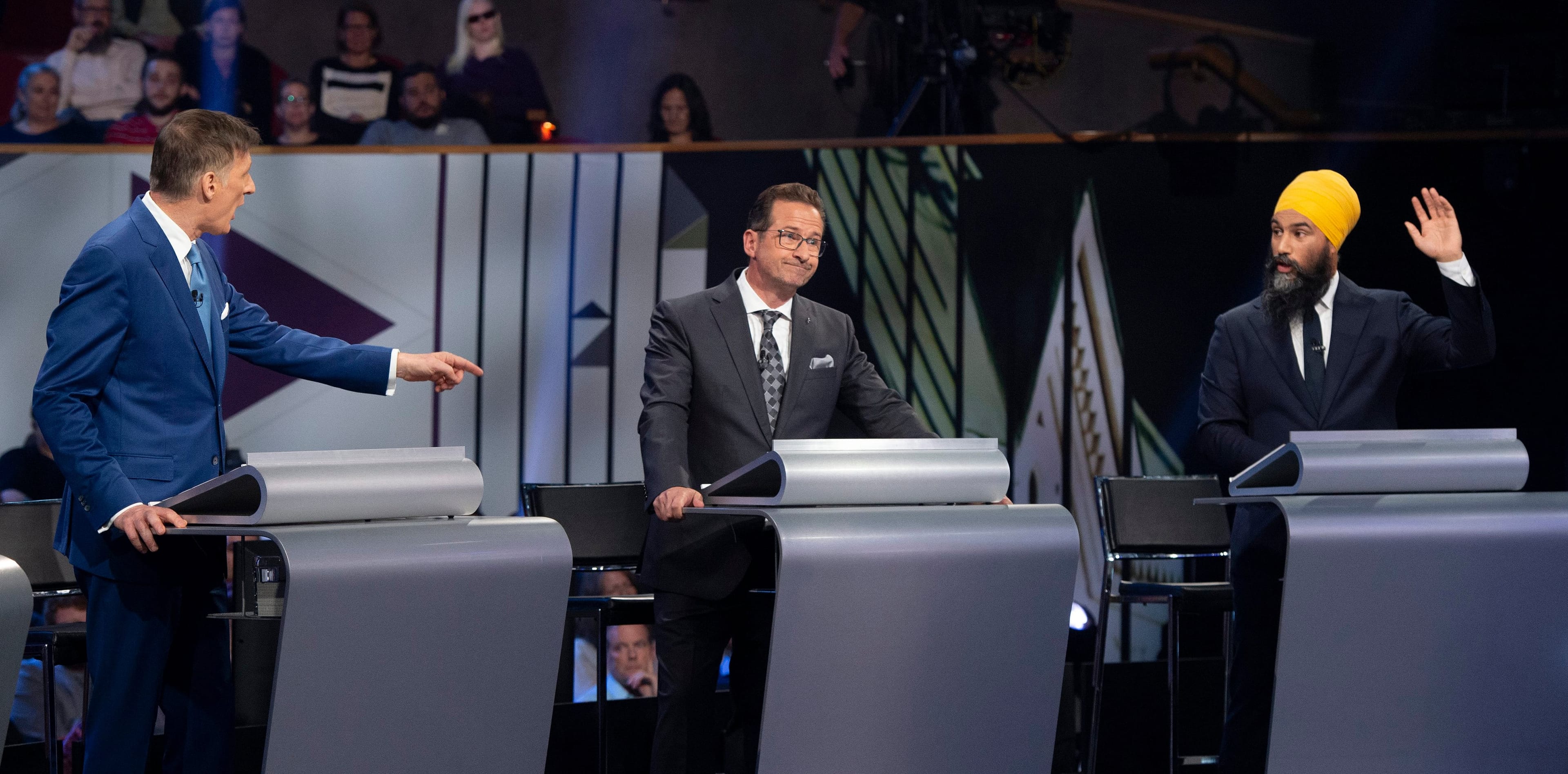 Blanchet, centre, listens to a tense exchange between Singh, right, and Bernier (Sean Kilpatrick/CP)