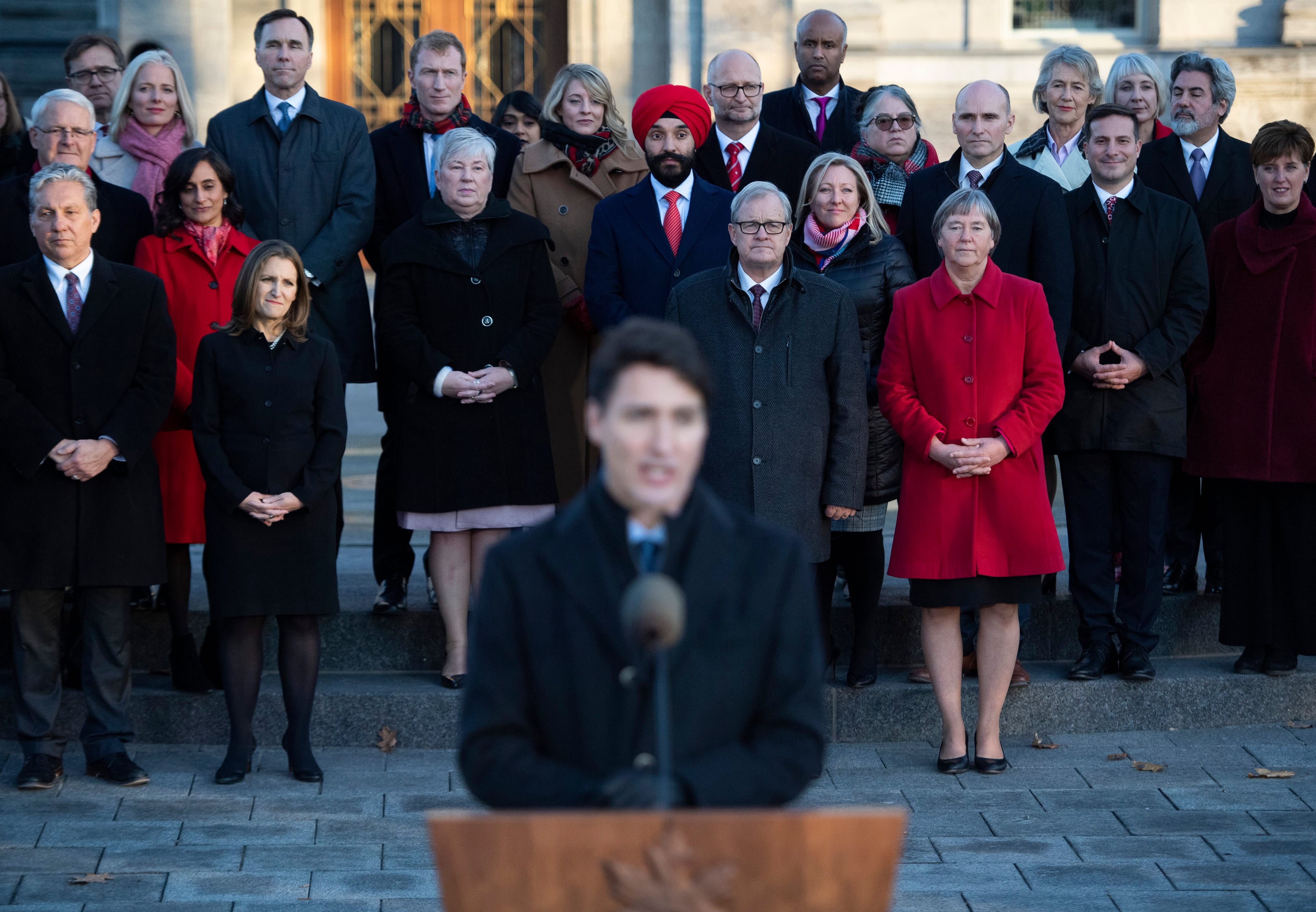 Members of cabinet stand behind Trudeau as he speaks to reporters following a swearing in ceremony at Rideau Hall on Nov. 20, 2019 (THE CANADIAN PRESS/Justin Tang)