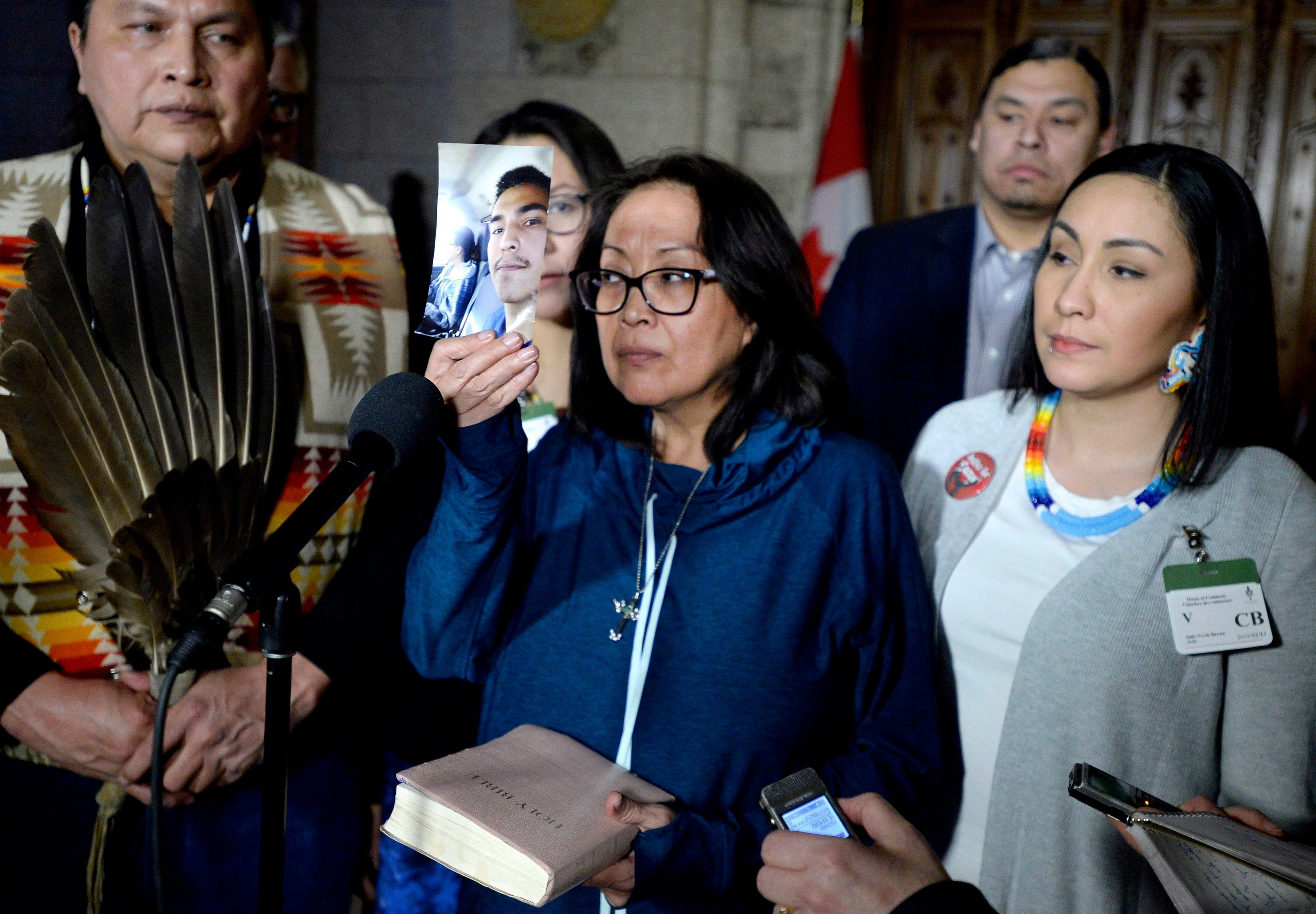 Debbie Baptiste, mother of murdered Colten Boushie, holds up a photo of her son as she speaks to reporters in the Foyer of the House of Commons after a day of meetings on Parliament Hill, in Ottawa on Feb. 13, 2018. (CP/Justin Tang)