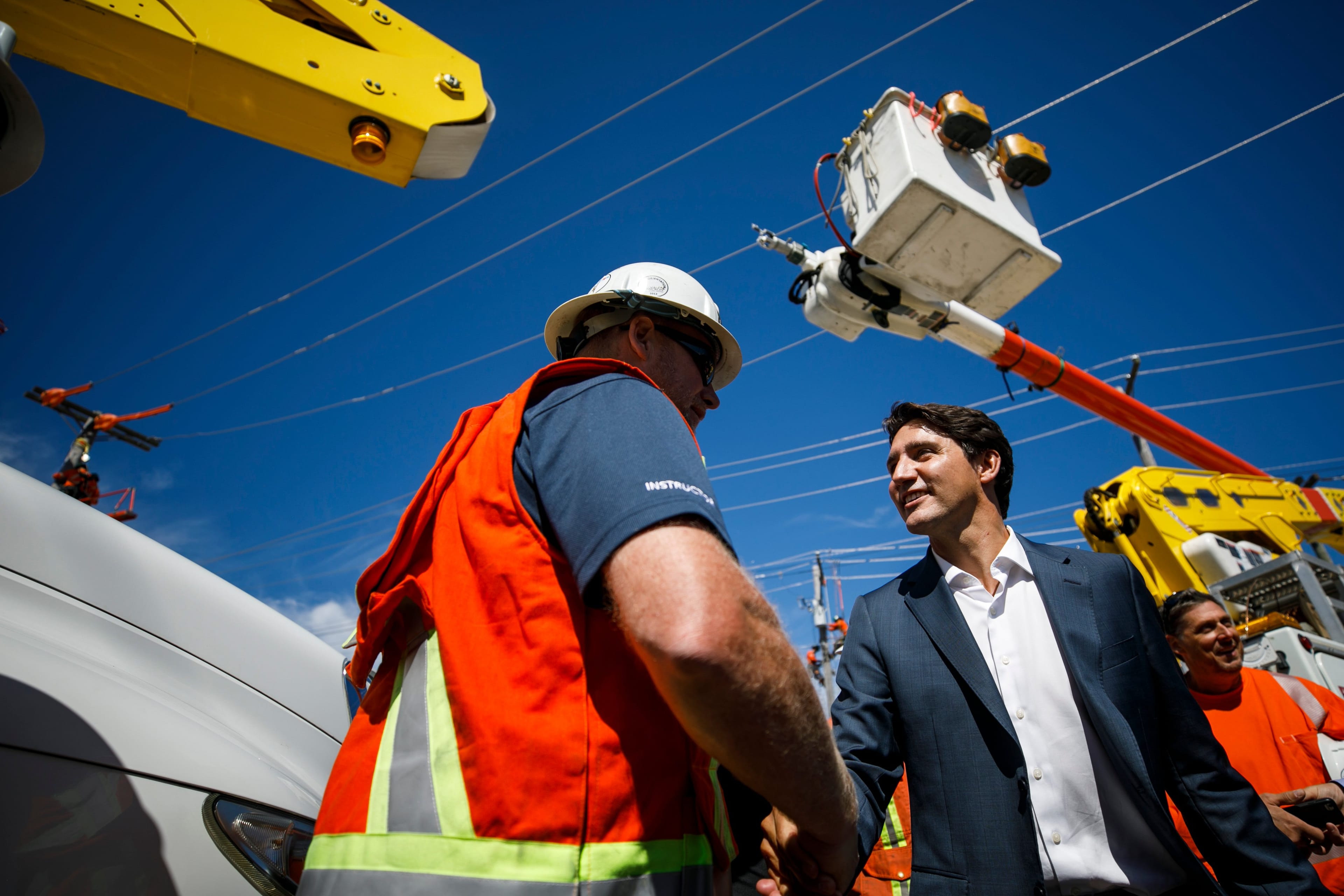 Trudeau, here greeting hydro workers in Surrey, will face a minority government and slow economic growth, making it difficult to keep fiscal discipline (Adam Scotti/PMO)