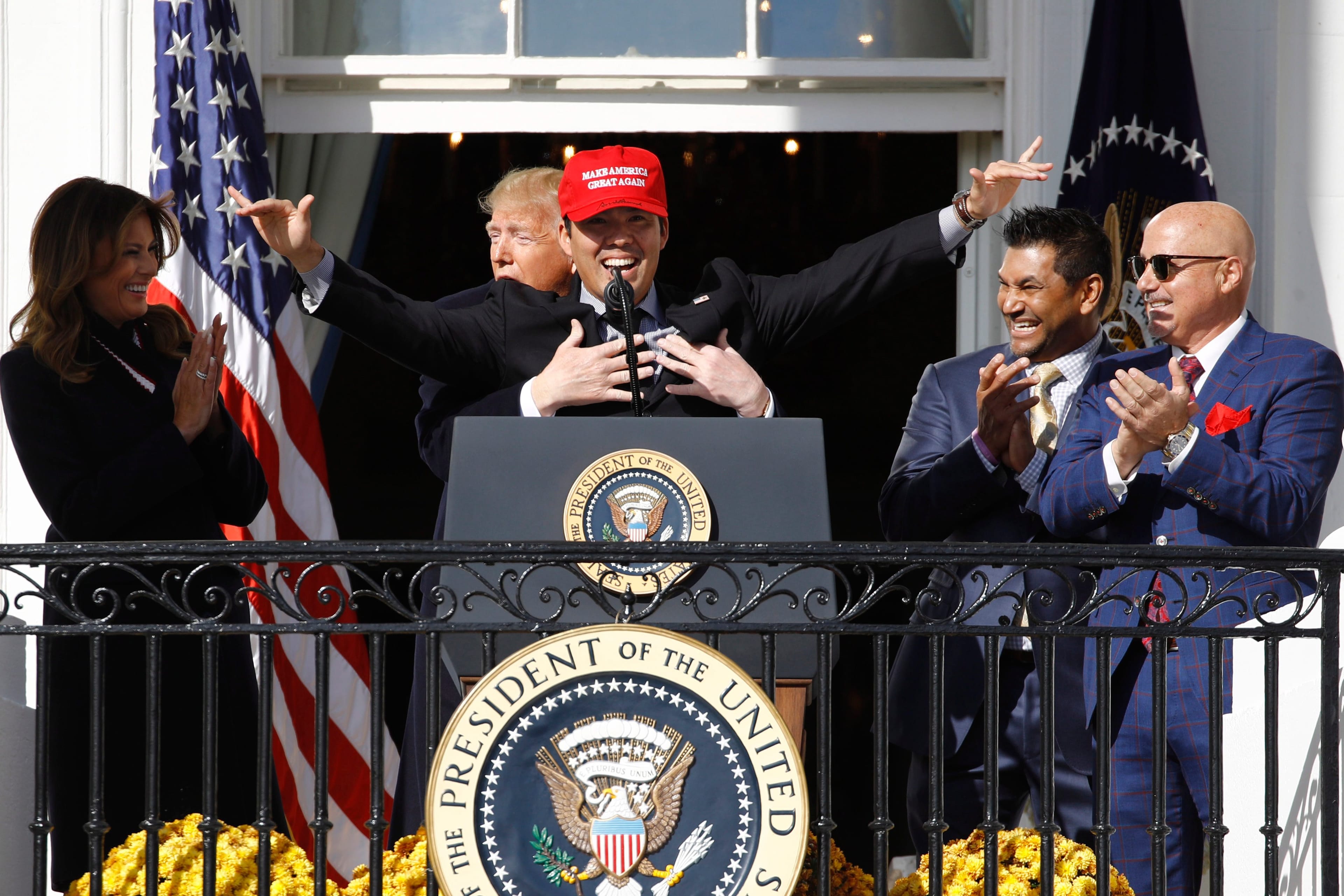 President Donald Trump hugs Washington Nationals catcher Kurt Suzuki, during an event to honour the 2019 World Series champion Washington Nationals on the balcony of the White House. (Patrick Semansky/AP/CP)