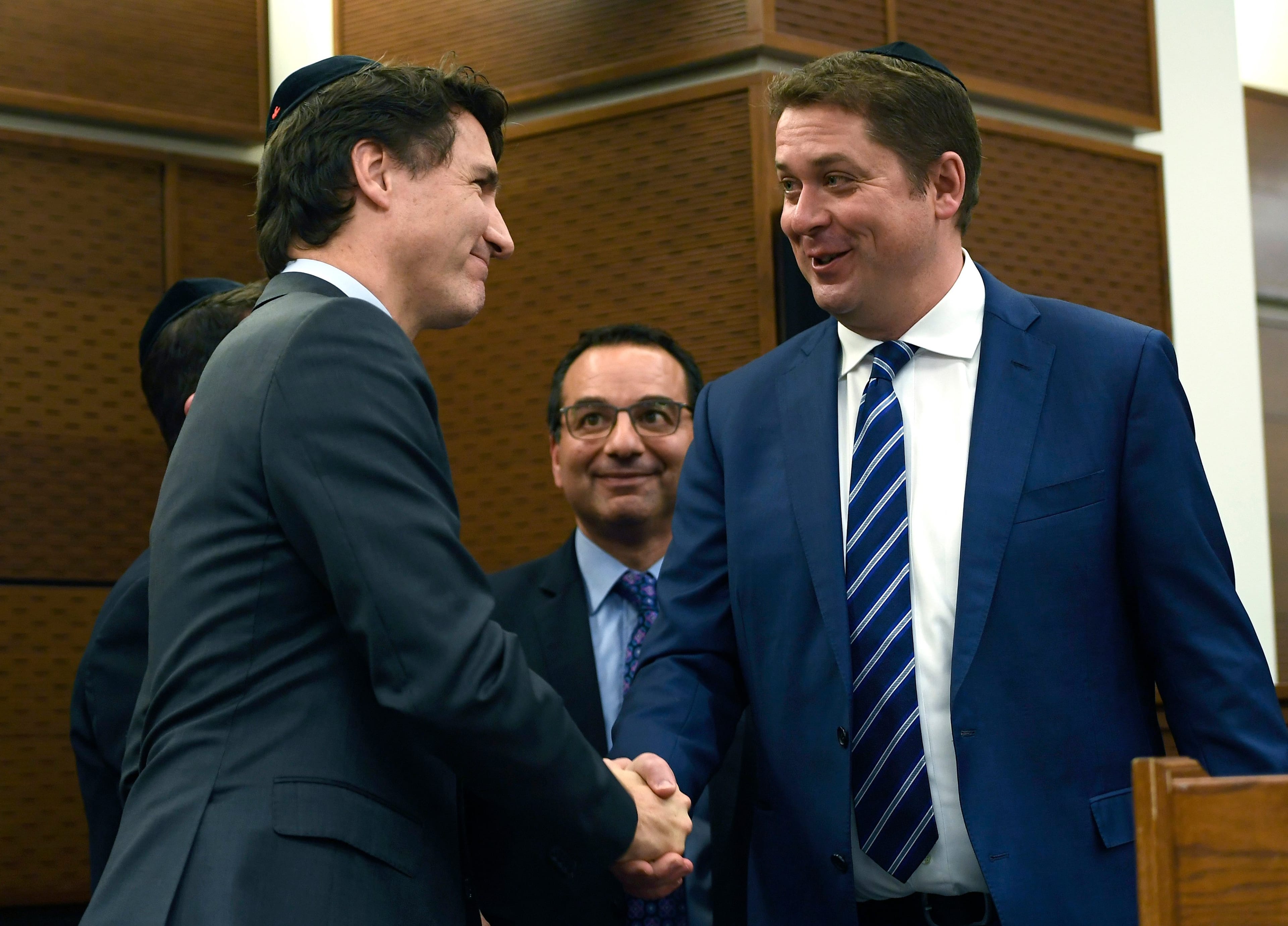 Prime Minister Justin Trudeau shakes hands with Conservative Leader Andrew Scheer after his remarks at Hanukkah on the Hill celebrations in Ottawa (Justin Tang/CP)