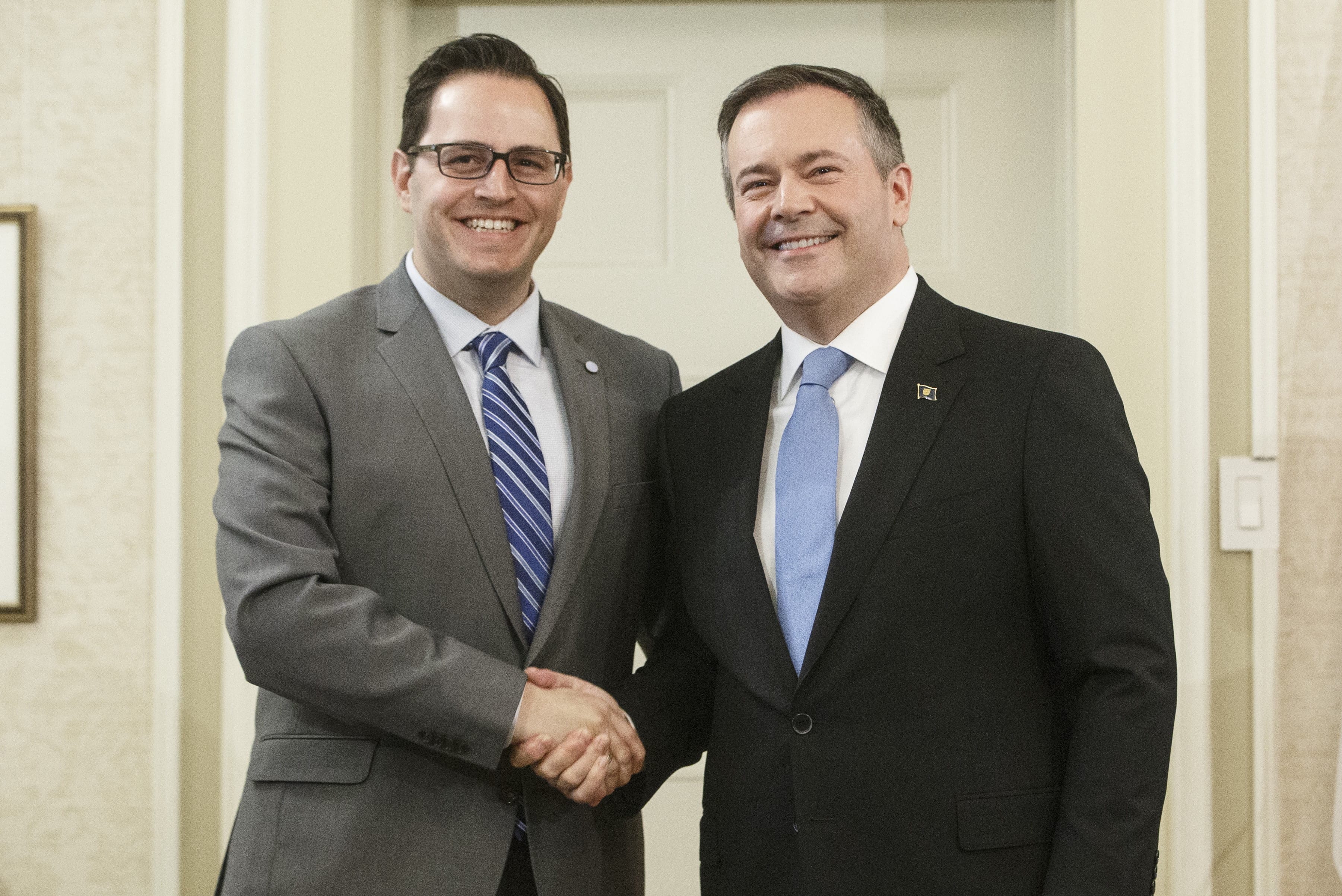 Alberta Premier Jason Kenney shakes hands with Demetrios Nicolaides, Minister of Advanced Education after being sworn into office, in Edmonton on Apr. 30, 2019. Alberta is launching a new funding model for post-secondary institutions, tying some of the public money to performance measures. (Jason Franson/CP)