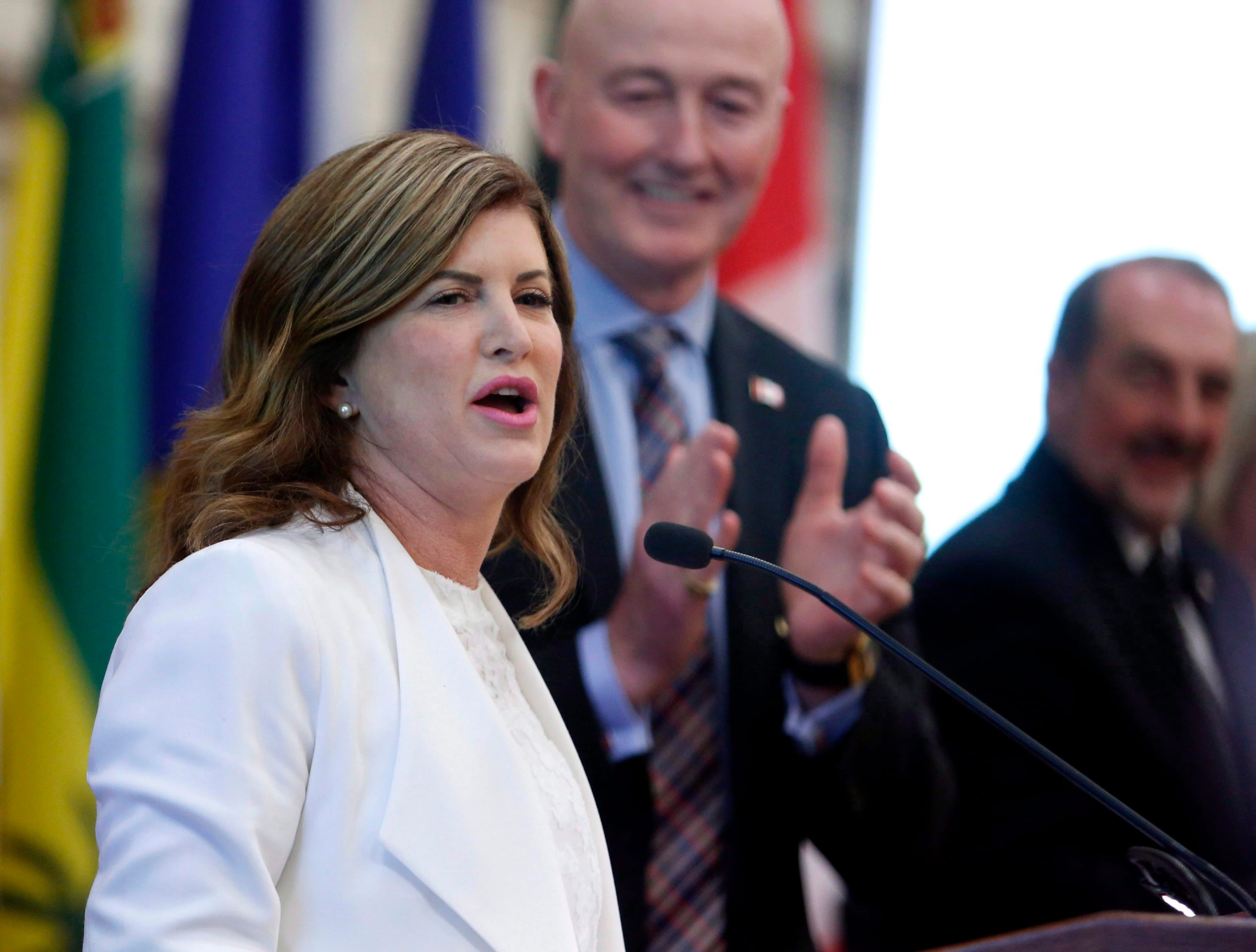 Rona Ambrose, then-interim leader of the Conservative Party of Canada, receives a standing ovation as she addresses the Conservative National Caucus in Ottawa on May 17, 2017. (Fred Chartrand/CP)