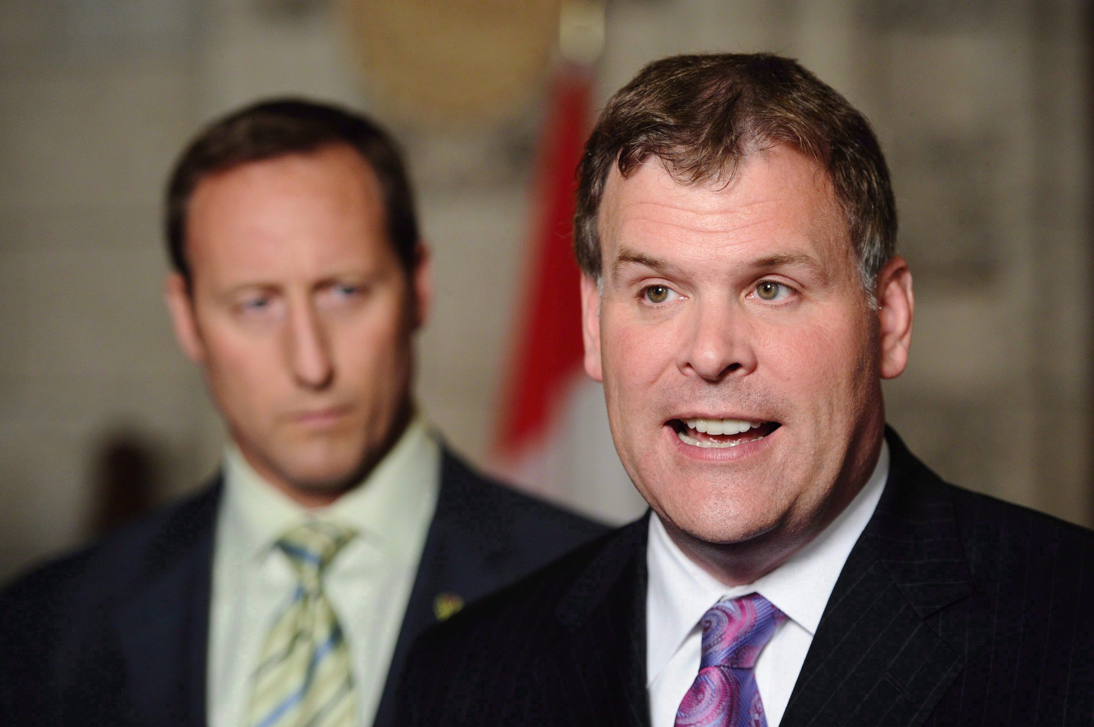 Then-Minister of Foreign Affairs John Baird (right) and then-Minister of Defence Peter MacKay speak to reporters in the foyer of the House of Commons in Ottawa on June 22, 2011. (Sean Kilpatrick/CP)