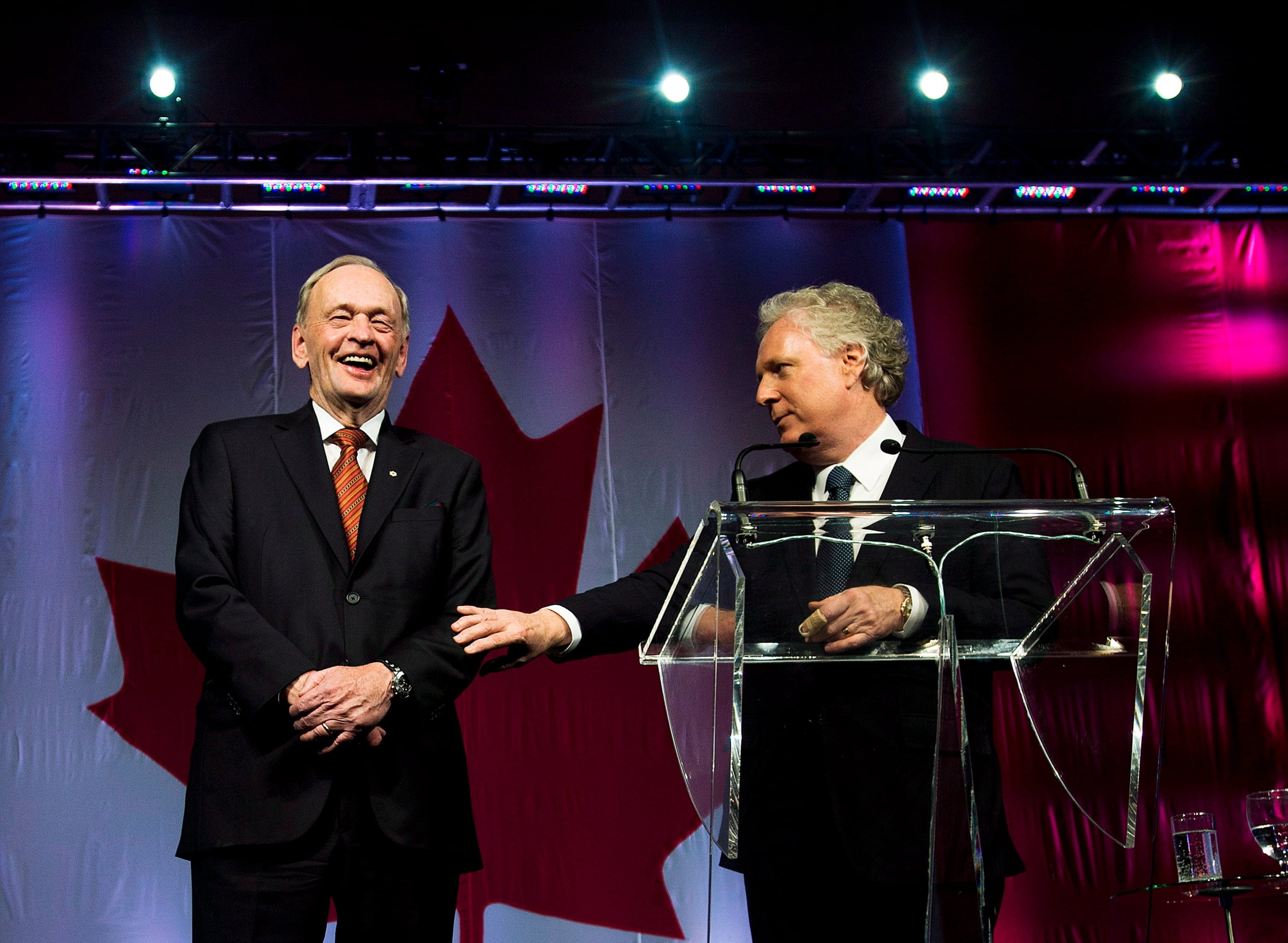 Former prime minister of Canada Jean Chretien, left, laughs with Jean Charest, right, after speaking during his 80th birthday and marking 50 years in public service in Toronto on Jan. 21, 2014. (Nathan Denette/CP)