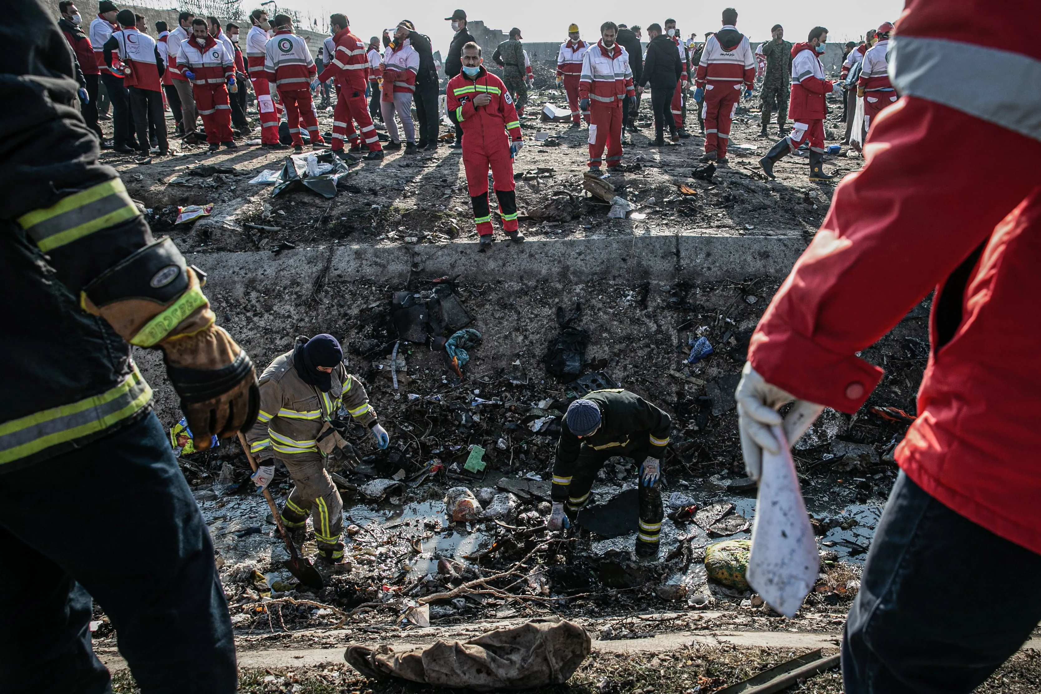 Rescue workers search the scene where the Ukrainian airplane crashed on Wednesday shortly after takeoff from Tehran airport (Foad Ashtari/Getty Images)